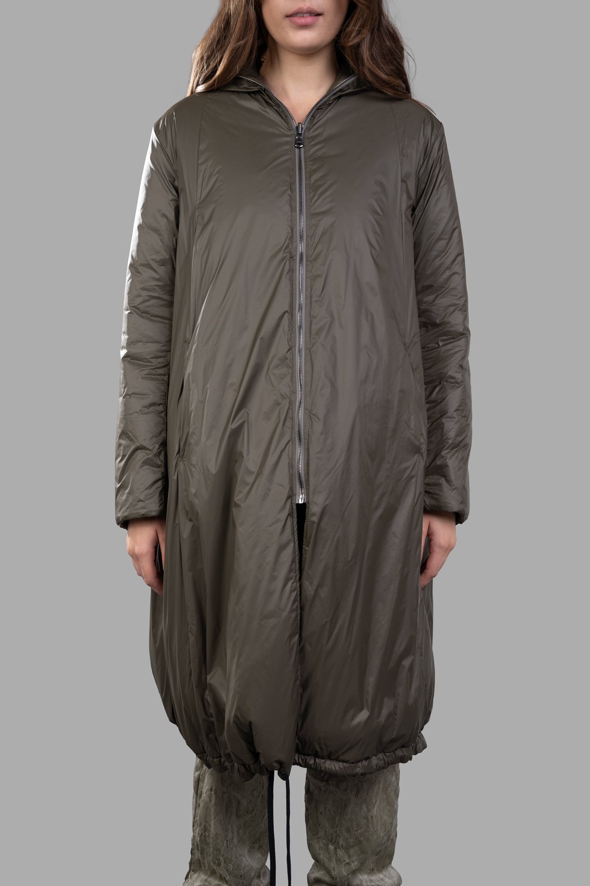 Masnada Layered Raincoat in dark green, featuring front zip closure, slouchy hood, and textured ripstop material.