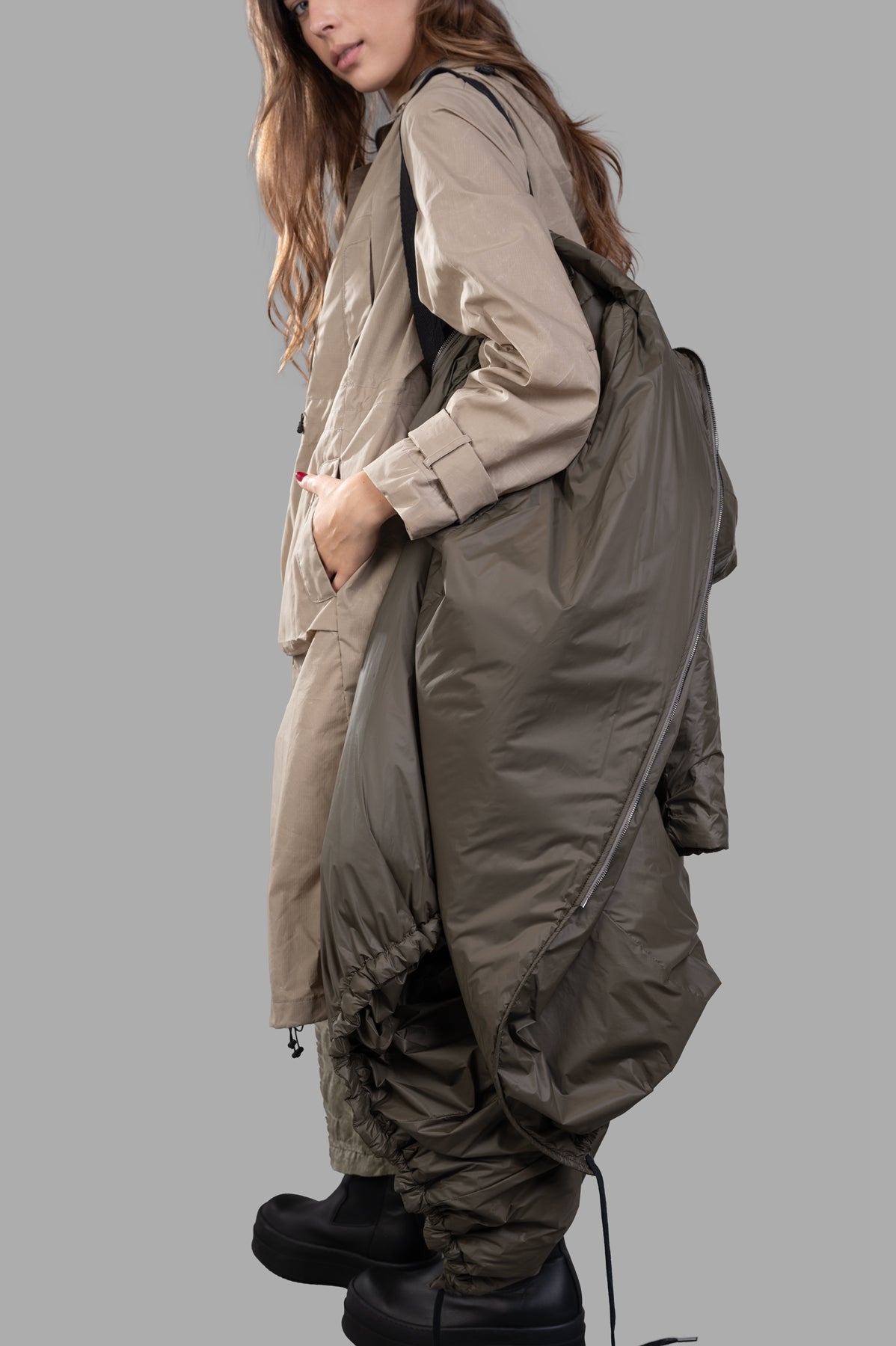 Masnada Layered Raincoat featuring a mix of beige and olive tones, shown on model with pockets and unique layered design.