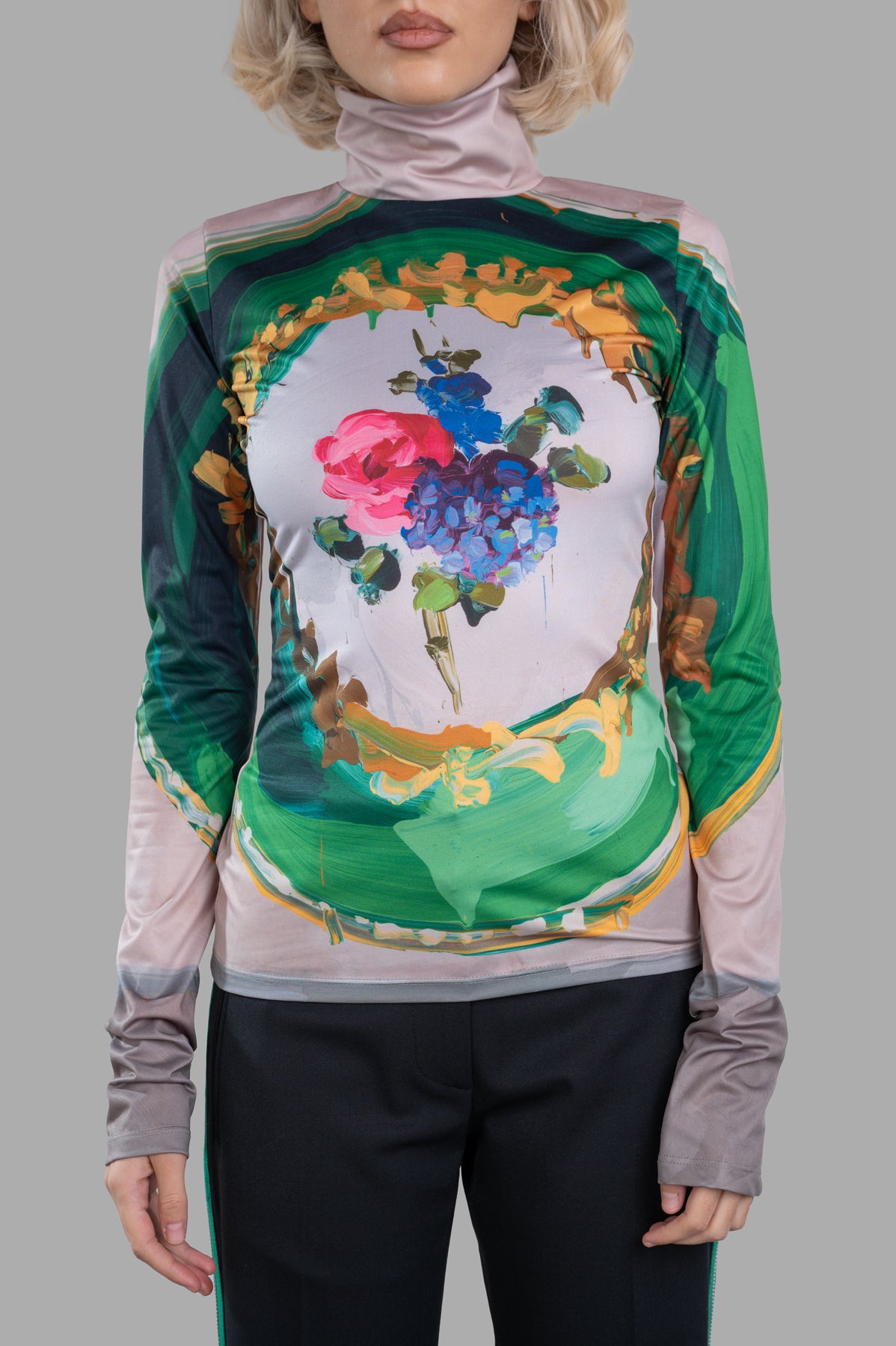 MSGM Floral-print Top features a striking multicolor floral design with a high neck and long sleeves on a model.