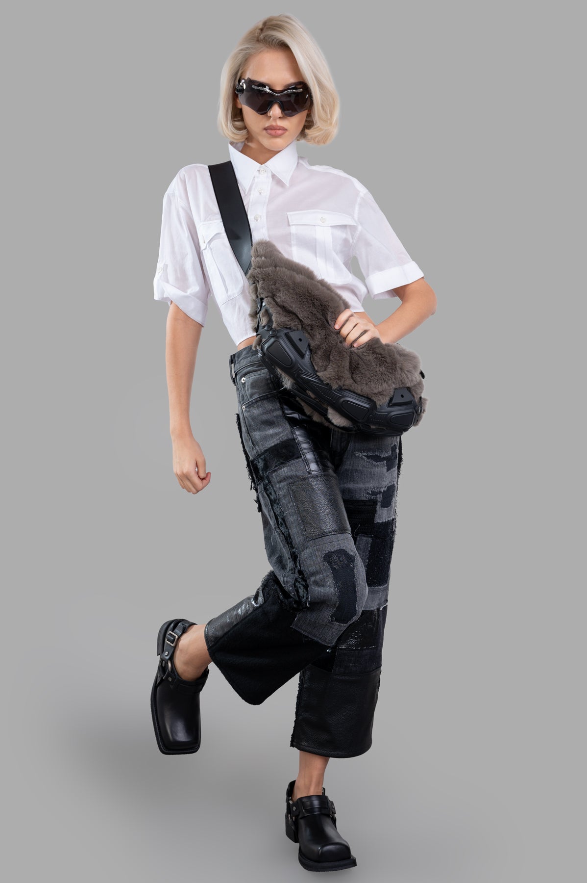Junya Watanabe Patchwork Jeans modeled in a front view, featuring black denim with faux leather and detailed patchwork.