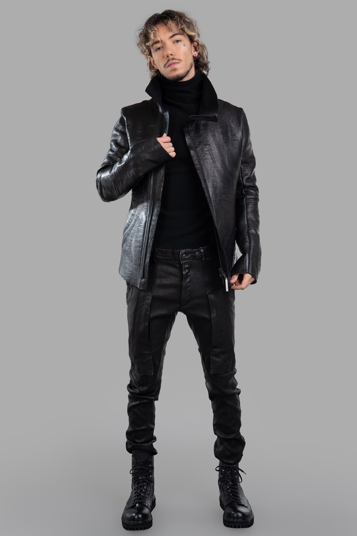 Isaac Sellam Creased Biker Jacket, front view on model, showcasing black lambskin, spread collar, and zip detailing.