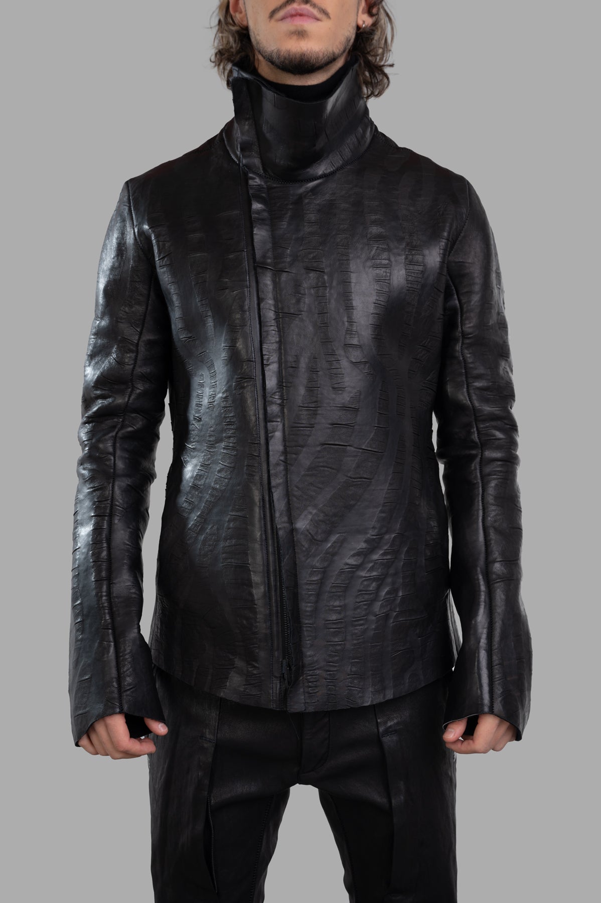 Isaac Sellam Creased Biker Jacket in black lambskin, showcasing unique texture and sophisticated design details, on model.