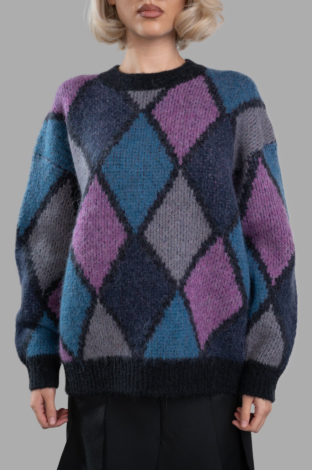 Anine Bing Sydney Crew Sweater features a cozy multicolor diamond design with black trim, shown on a model.