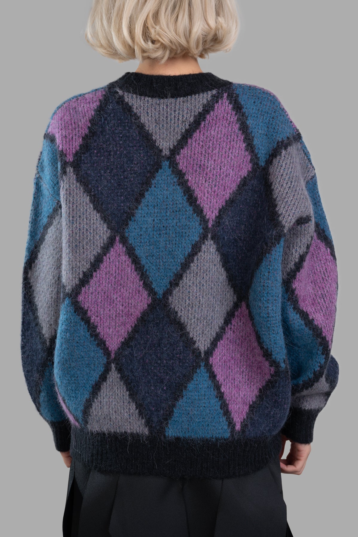 Anine Bing Sydney Crew Sweater displays a warm, vibrant diamond motif with sleek black accents, highlighted from the side.