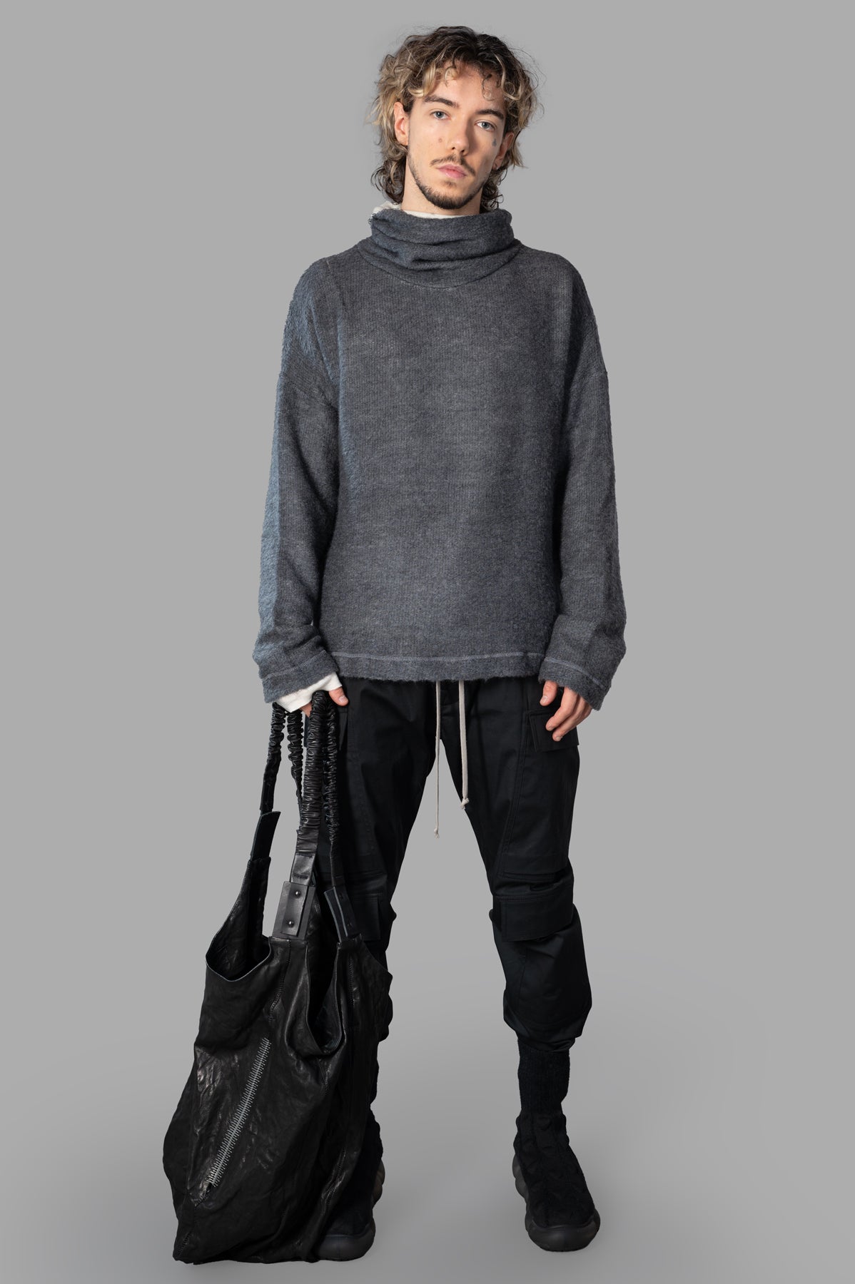 Marc Point grey roll-neck sweater, front view, showcasing relaxed fit and layered effect, worn by model.