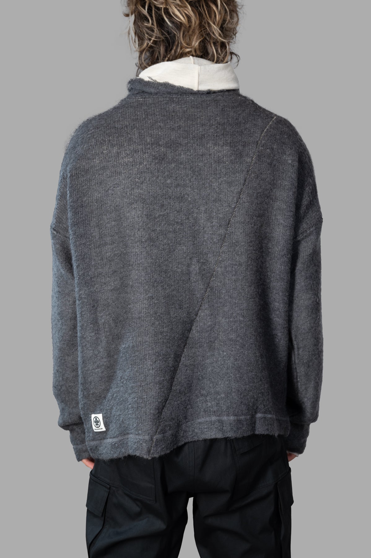 Marc Point Roll-neck Sweater in grey, showcasing relaxed fit and dropped shoulders, viewed from the back on a model.