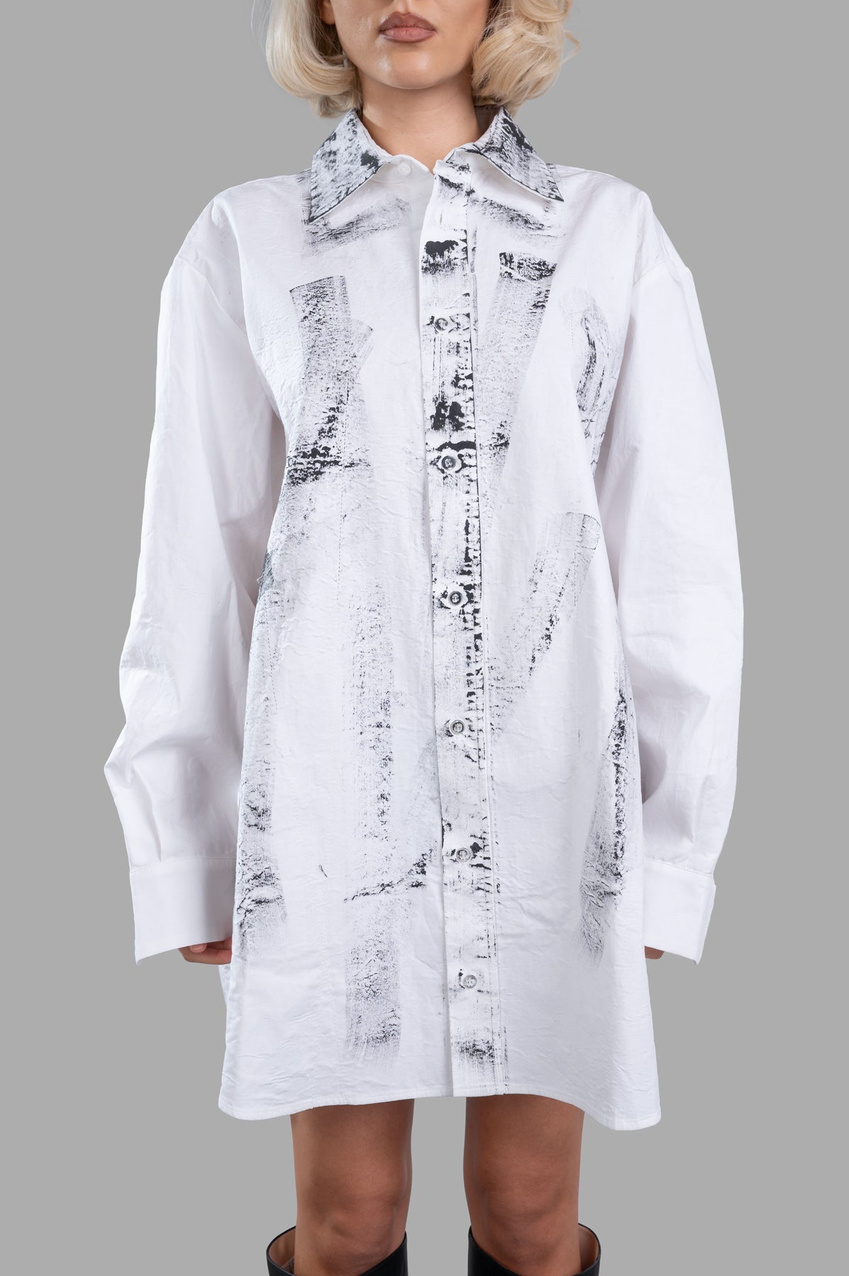 Giovanni Cavagna Printed Shirt Dress features an oversized design with striking black stains on white cotton, styled on.