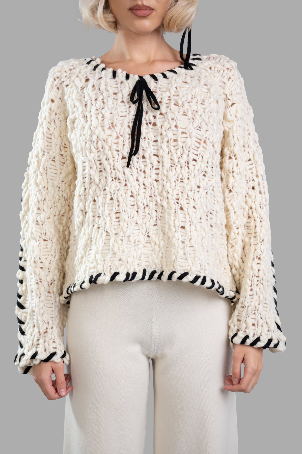 By Malene Birger Milea Sweater in off white, chunky knit with braided ties, featuring a textured design, styled on model.