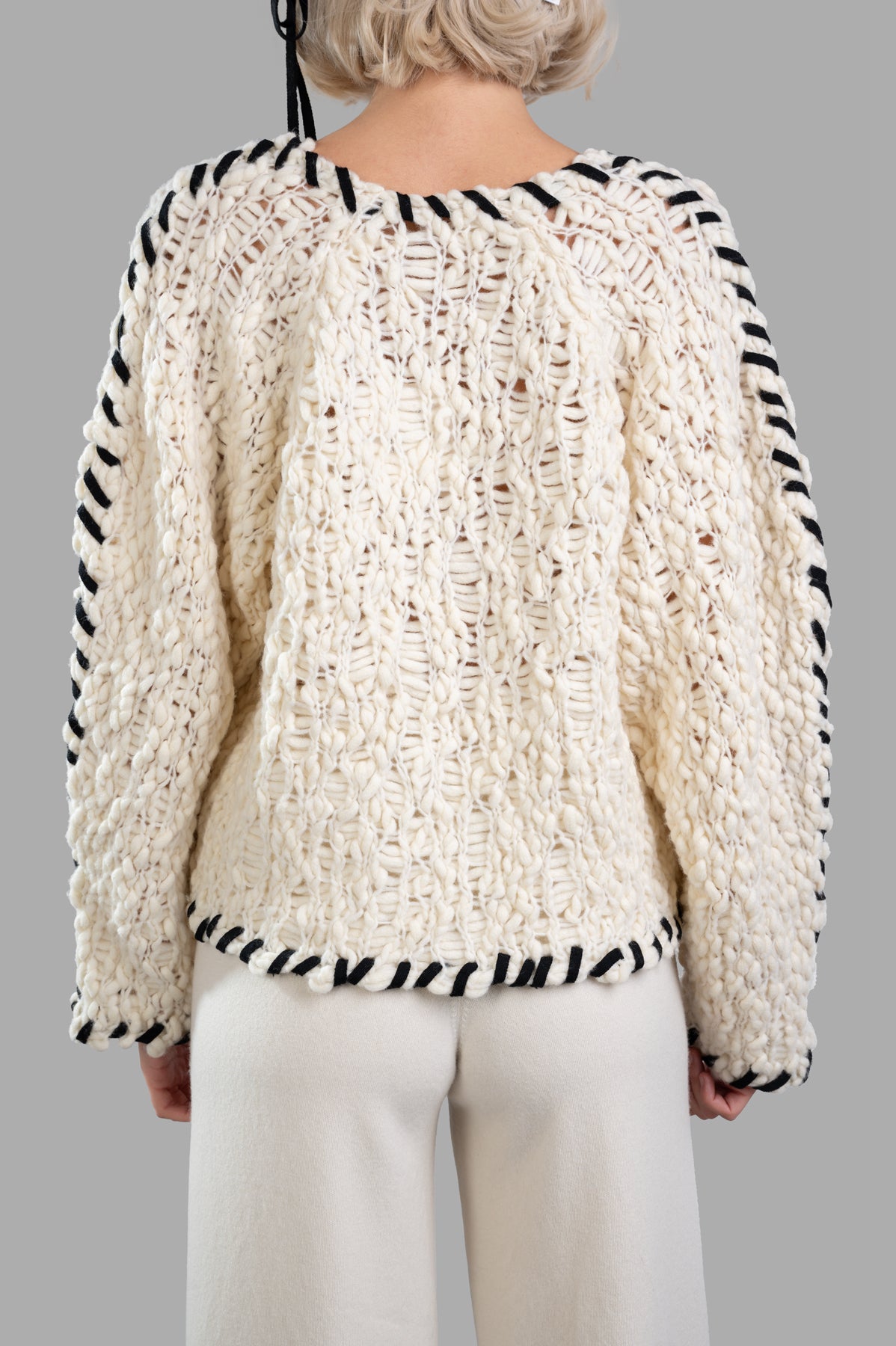 By Malene Birger Milea Sweater back view showcasing chunky wool blend knit with braided ties and textured design. Off-white.