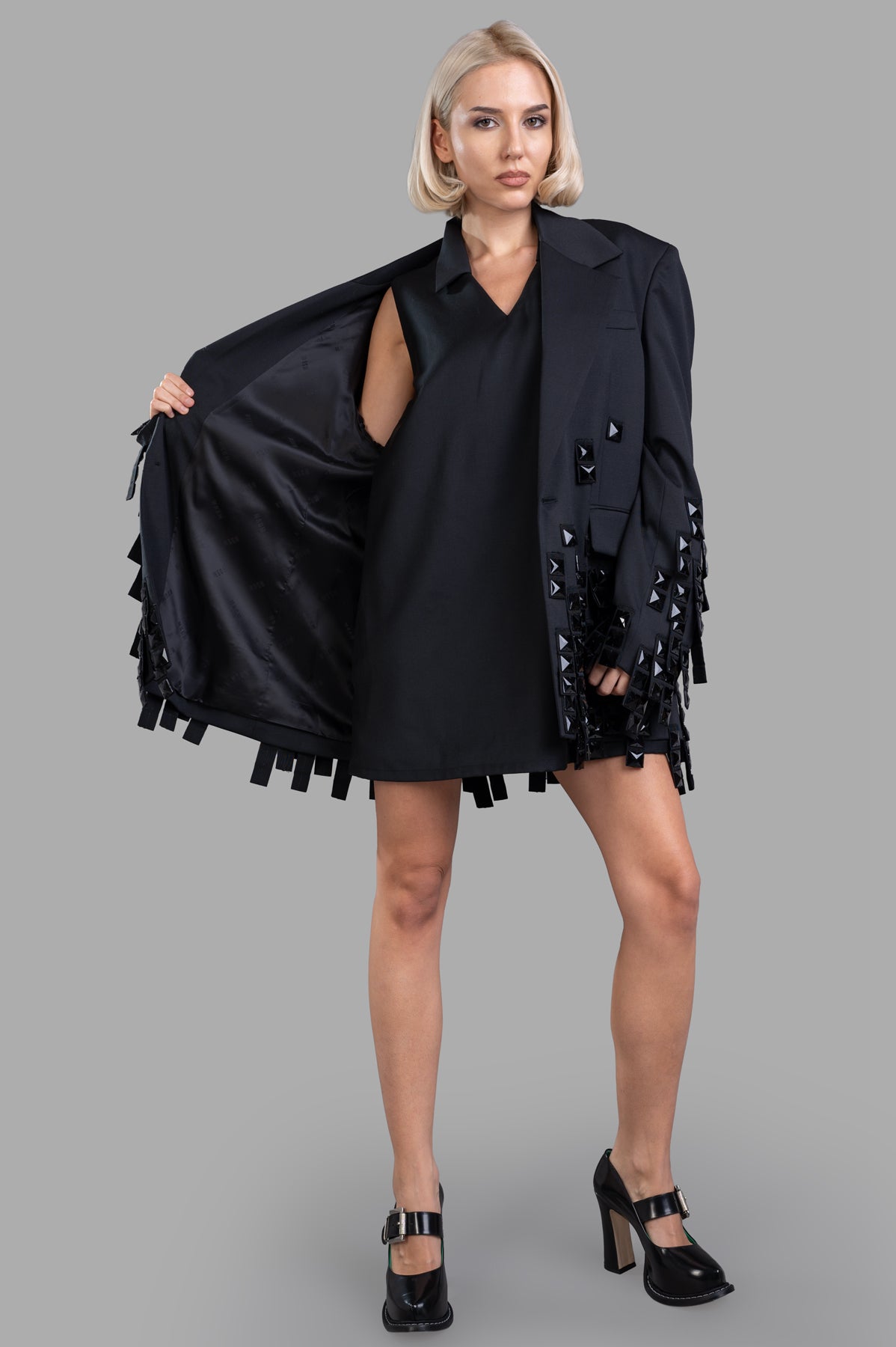Natasha Zinko Collar Dress, black A-line mini with V-neck, classic collar, front view on-model, embellished details.