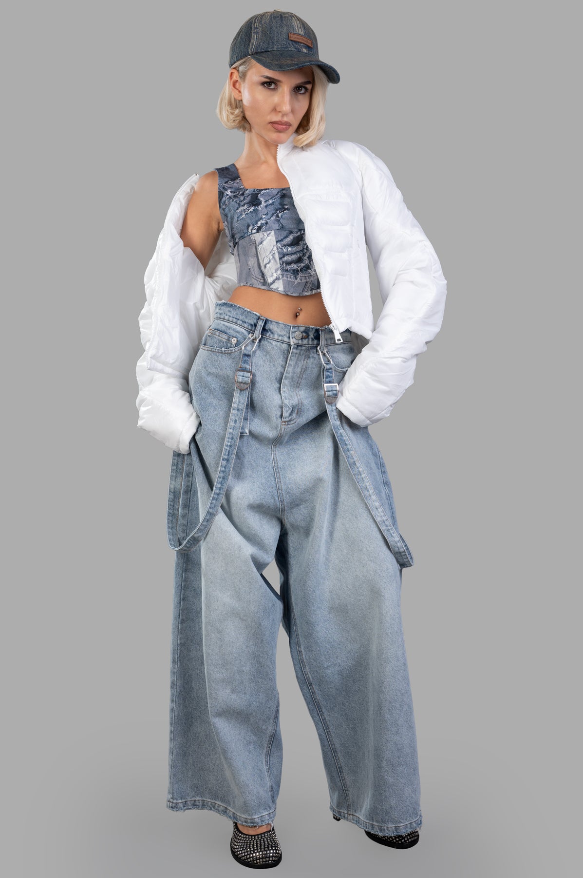 Natasha Zinko Muscle Puffer Jacket in white, on-model, featuring quilted design, mock neck, and padded comfort.