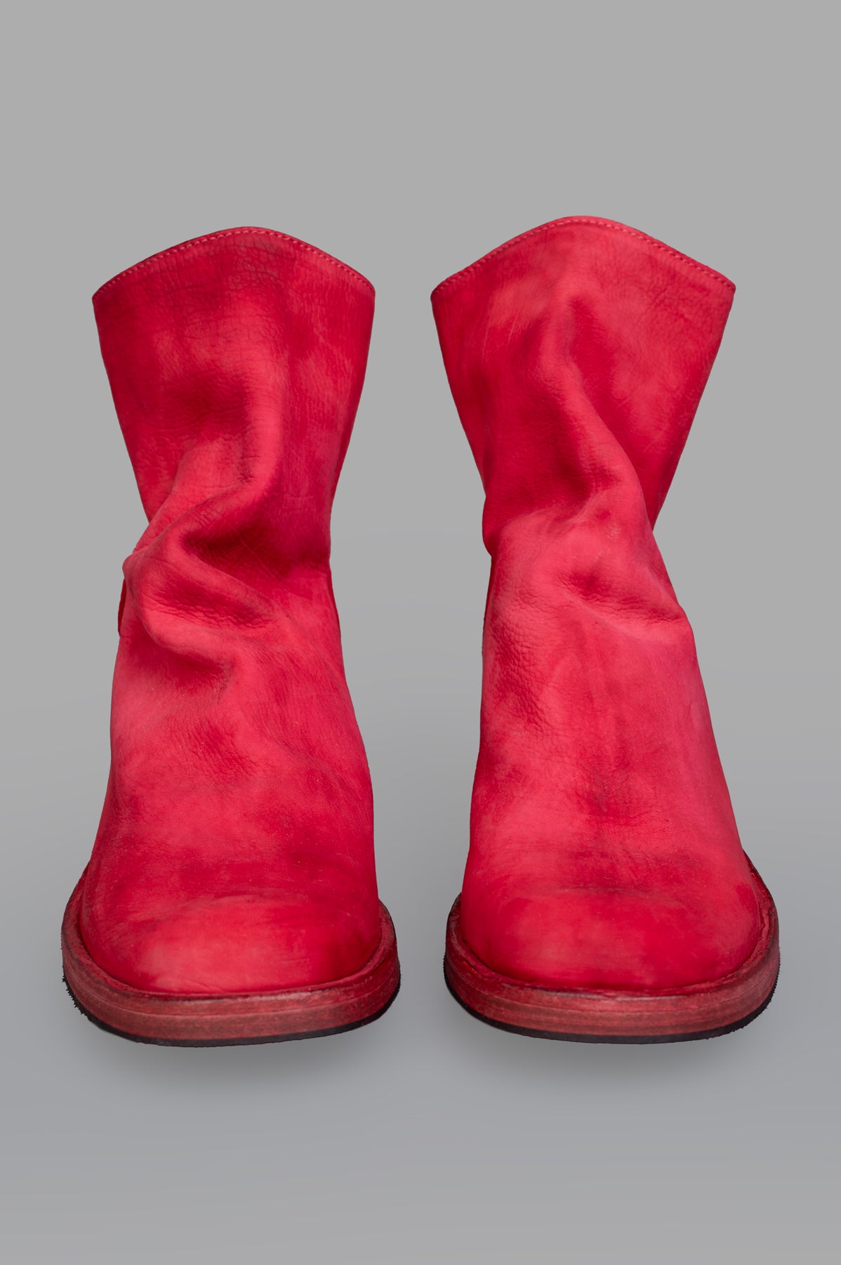 Shoto Back Zip Boots in vibrant red showcase a unique scrunched design, viewed from the front for stylish flair.