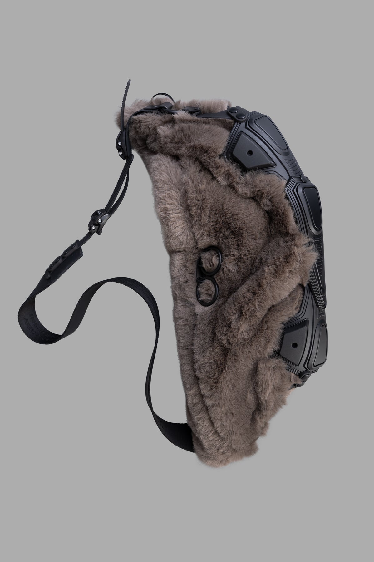 Innerraum Object M07 Crossbody Bag side view, featuring faux fur and black matte finish with an adjustable strap.