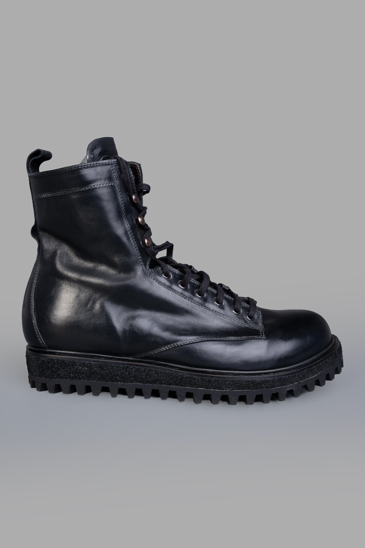 Shoto Lace-up Boots in black leather, side view showcasing durable rubber sole and sophisticated design.