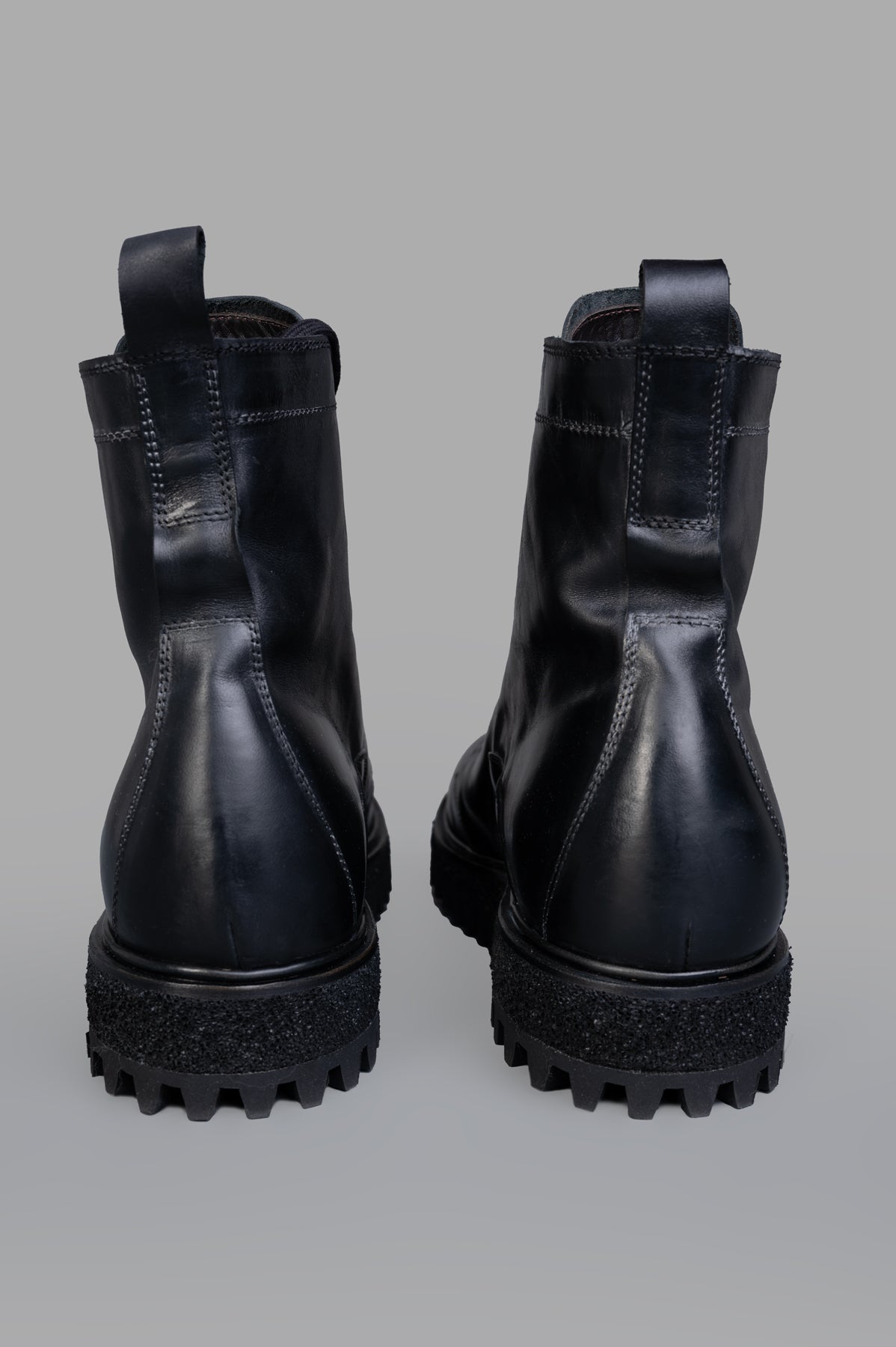 Shoto. Black Lace-up Boots with durable rubber sole, featuring a sleek leather design and stylish back detail.