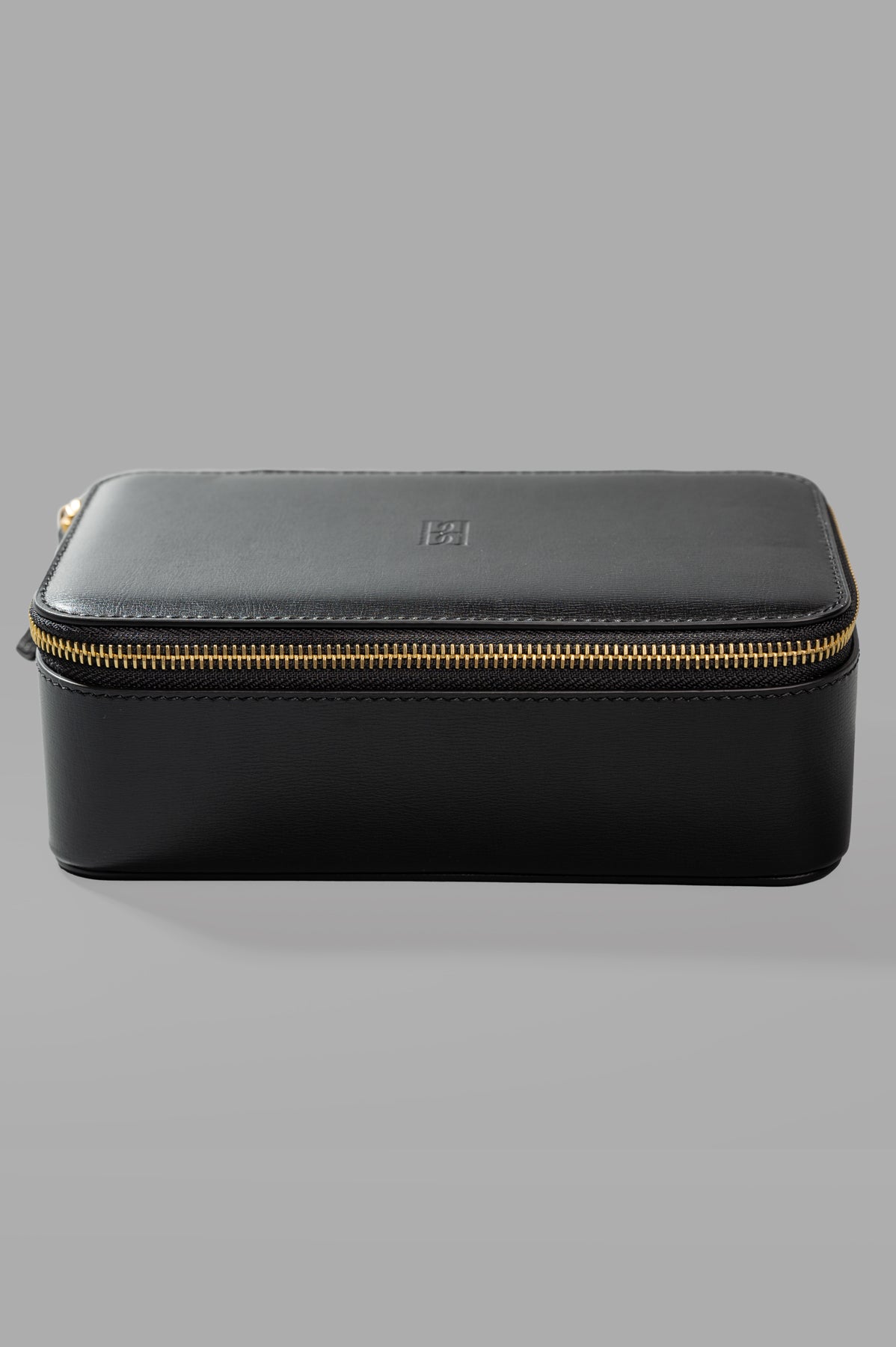 By Malene Birger Aya Cosmetic Case, front view showing black leather with gold zipper detail.