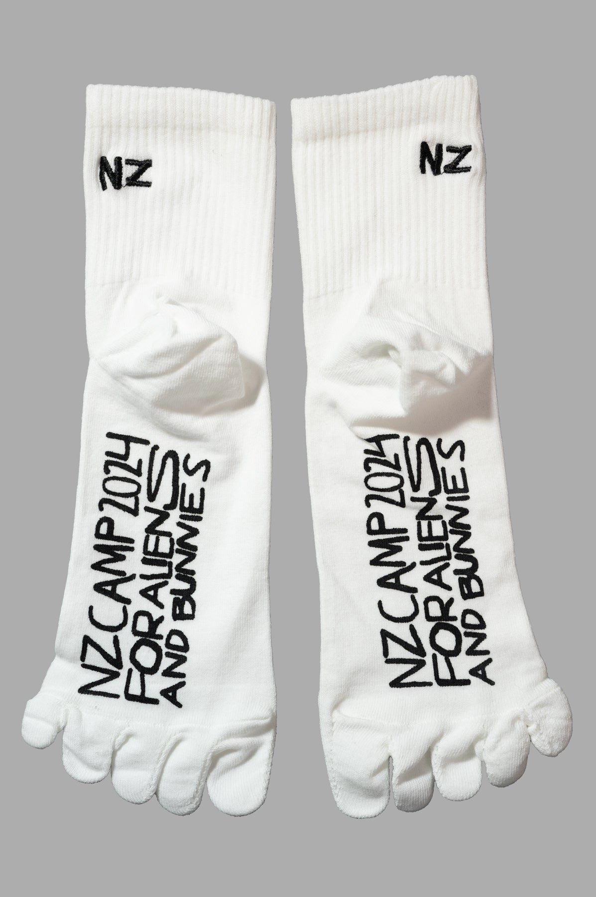 Natasha Zinko Alien Camp Socks, top view, with black "NZ CAMP 2014 FOR ALIENS AND BUNNIES" text and toe detail.