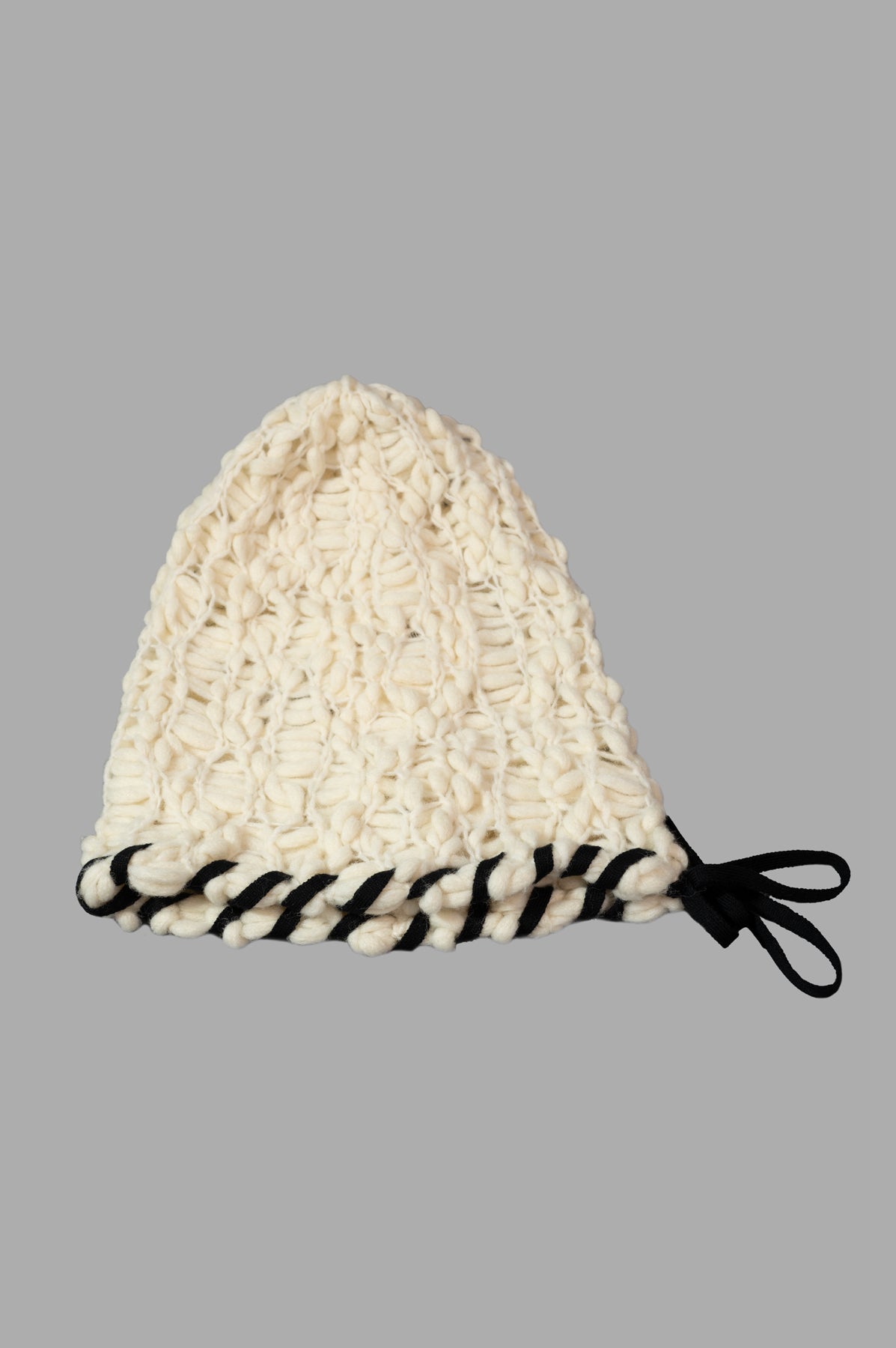 By Malene Birger Mossy Wool Hat in soft white, side view with braided tie-string, showcasing cozy knit texture.