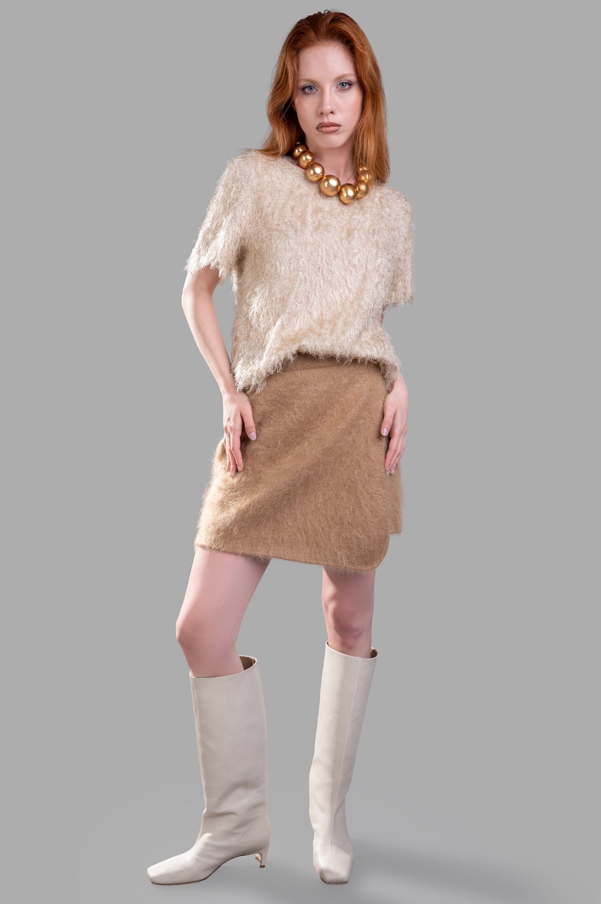 By Malene Birger Krissah Mini Skirt in brown mohair-blend, shown front view on-model with a textured, fluffy finish.