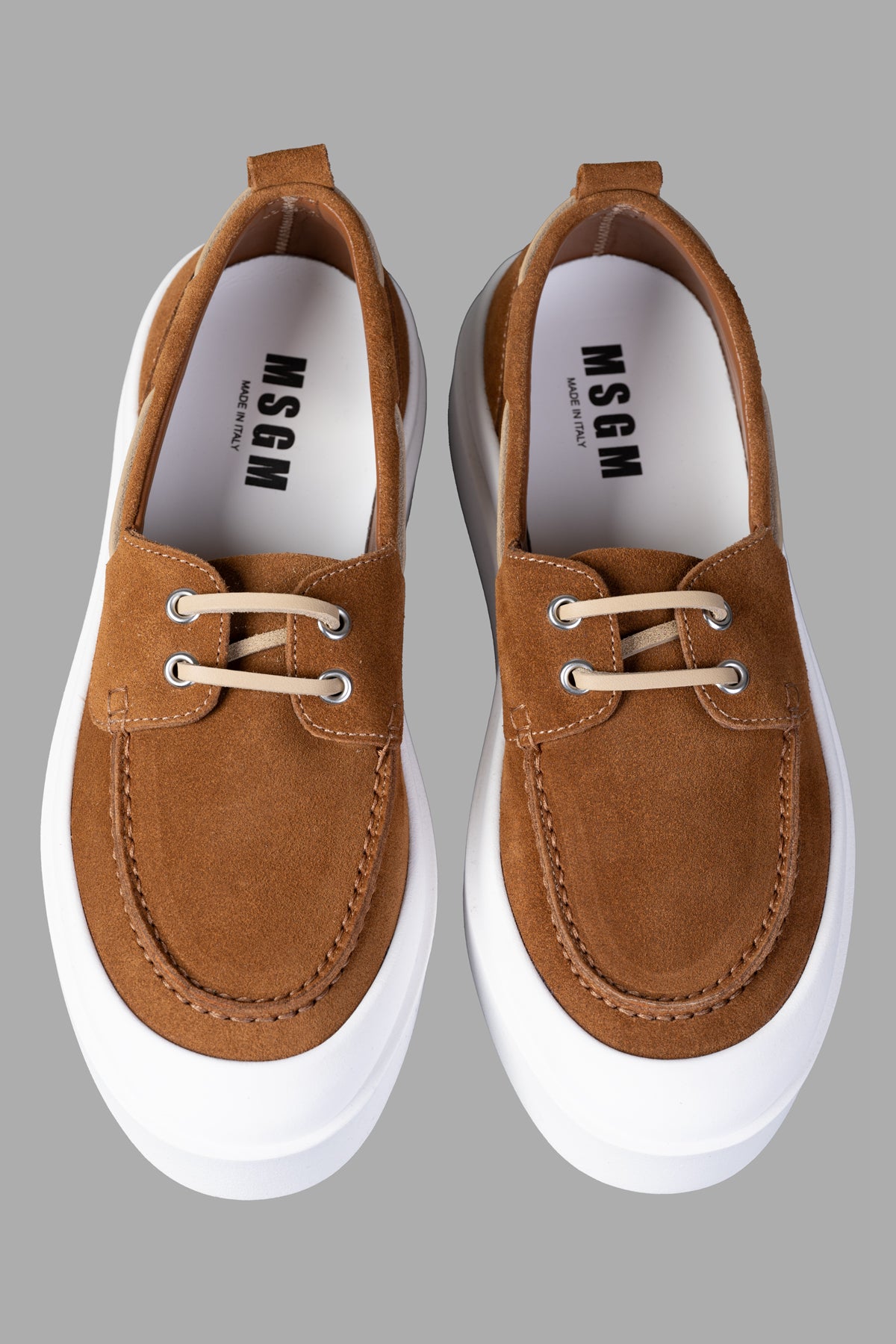 MSGM Suede Loafers in brown feature lace-up detailing, flat rubber sole, and pull-tab for easy wear. Top view highlights.