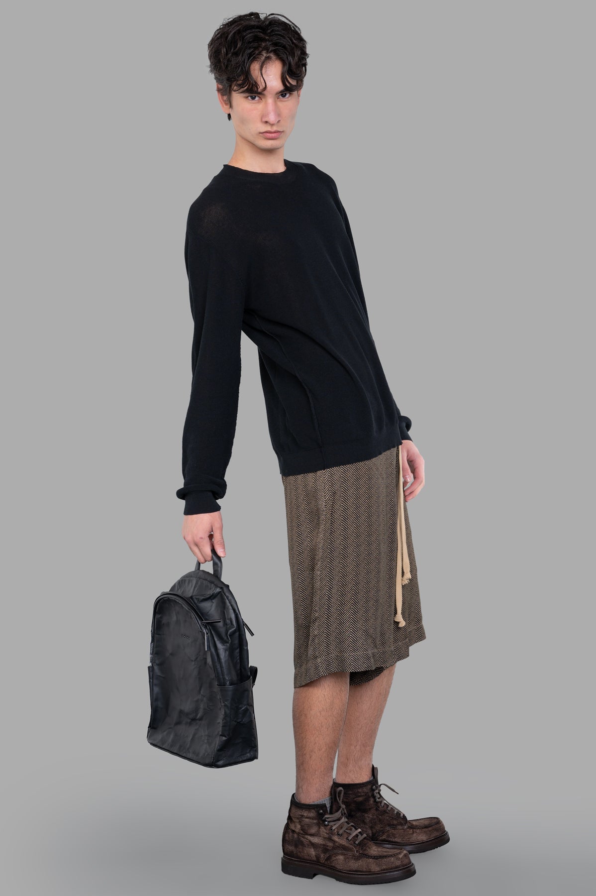 Uma Wang Fine-knit Sweater in black, relaxed-fit style, featuring round neck and textured detail, worn by model.