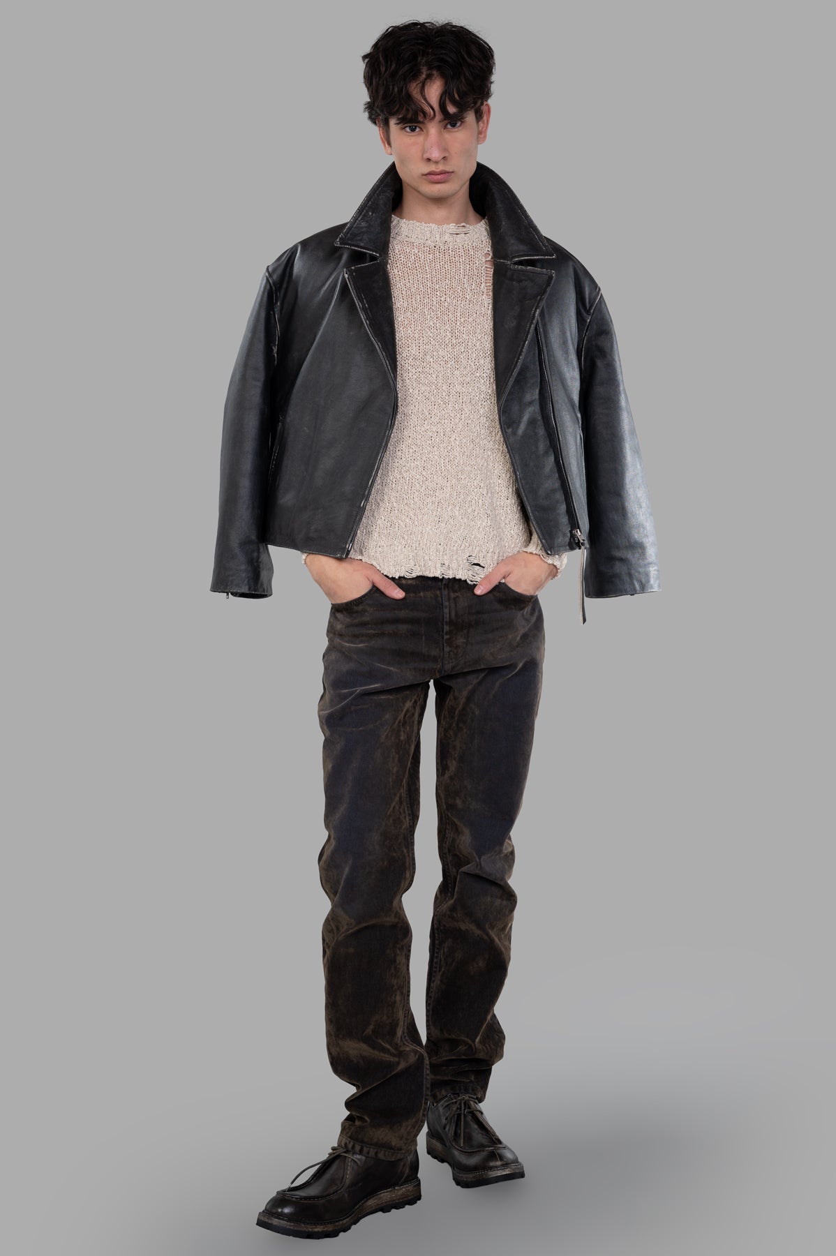 Avant Toi Distressed Sweater in beige, worn under a black leather jacket, showcasing front view with textured details.