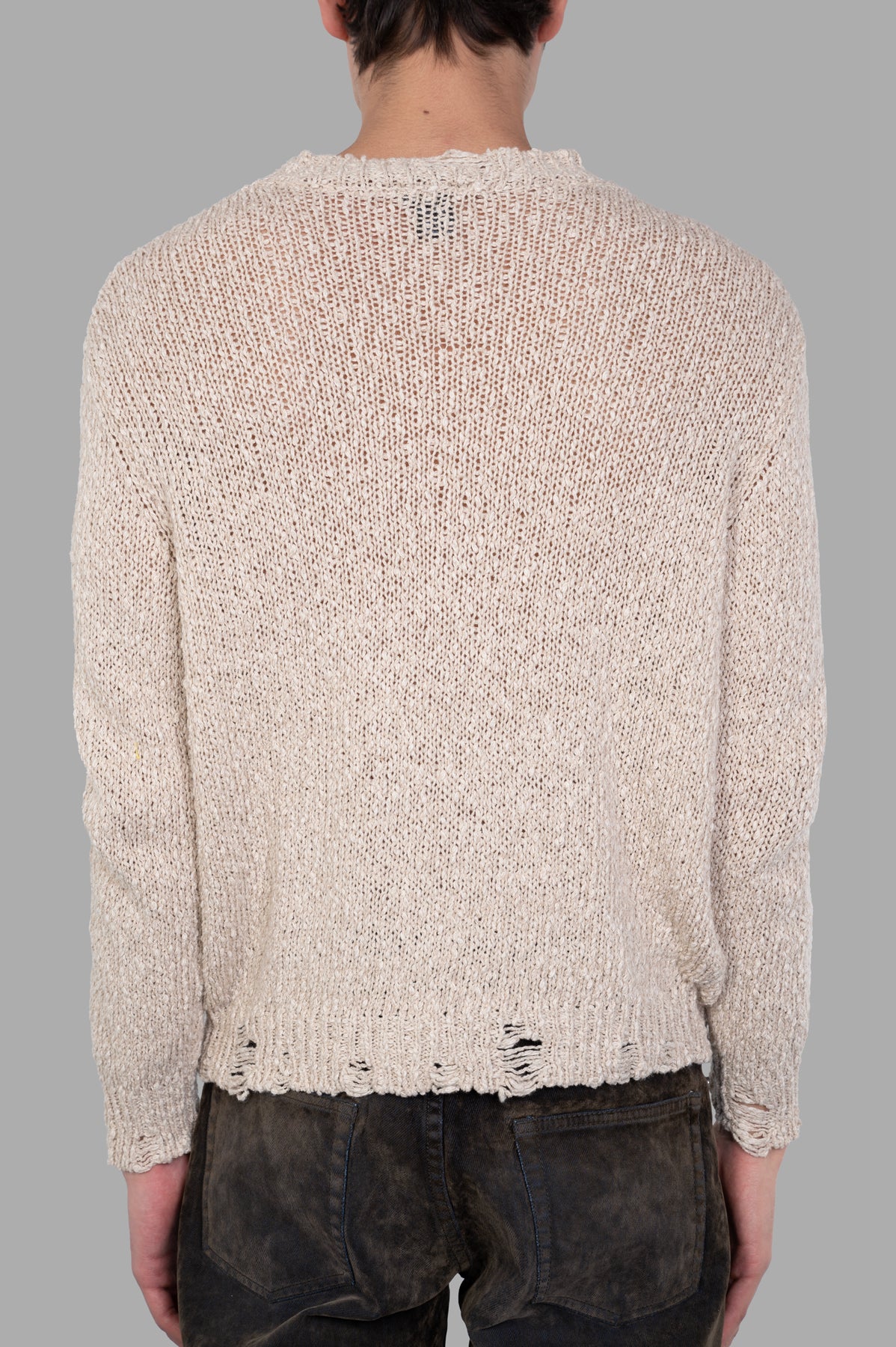 Avant Toi Distressed Sweater displayed from the back, featuring a vintage beige design with unique distressed details.
