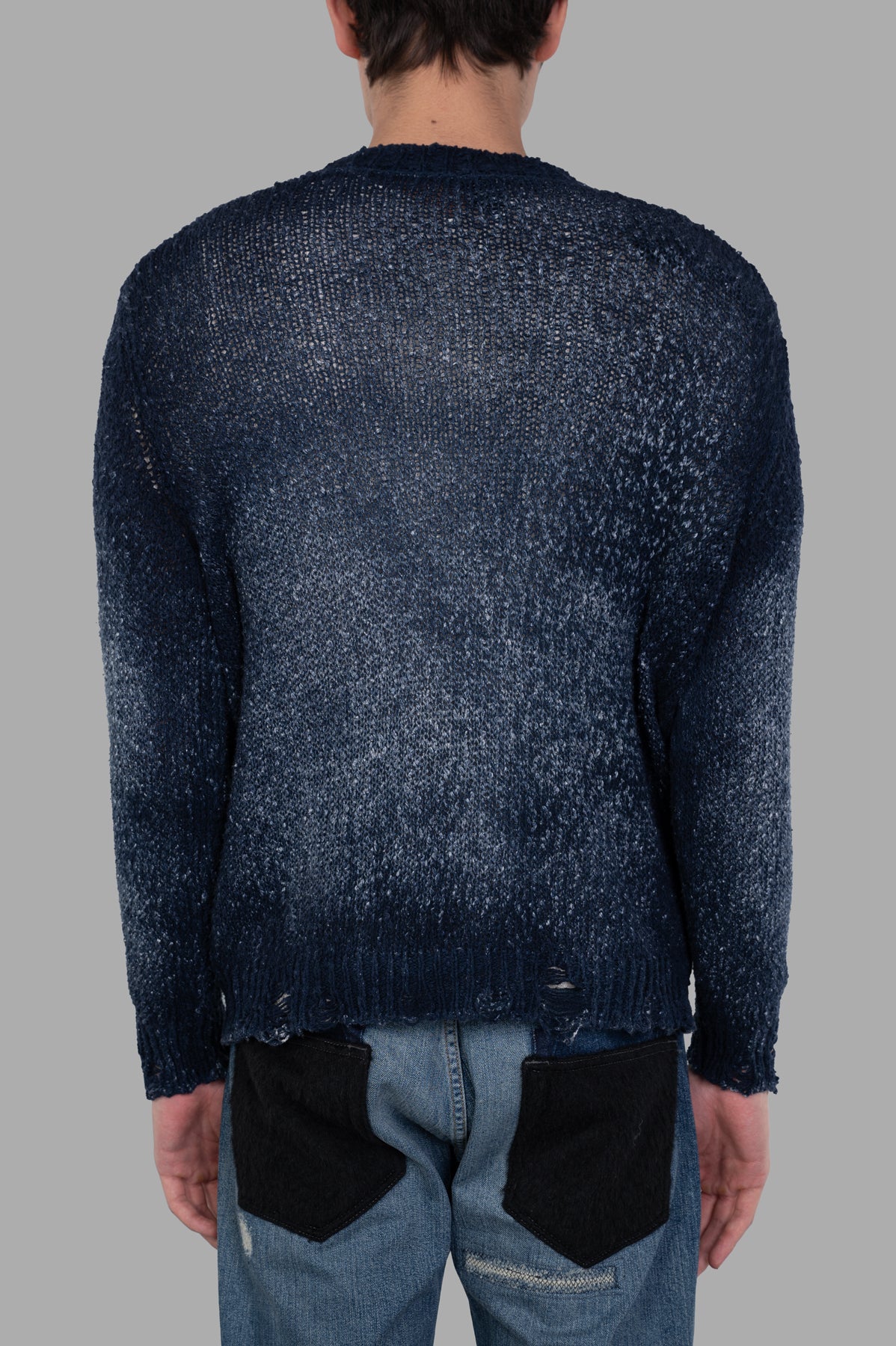 Avant Toi Distressed V-neck Cardigan shown in blue, featuring a faded effect and distressed details at the back.