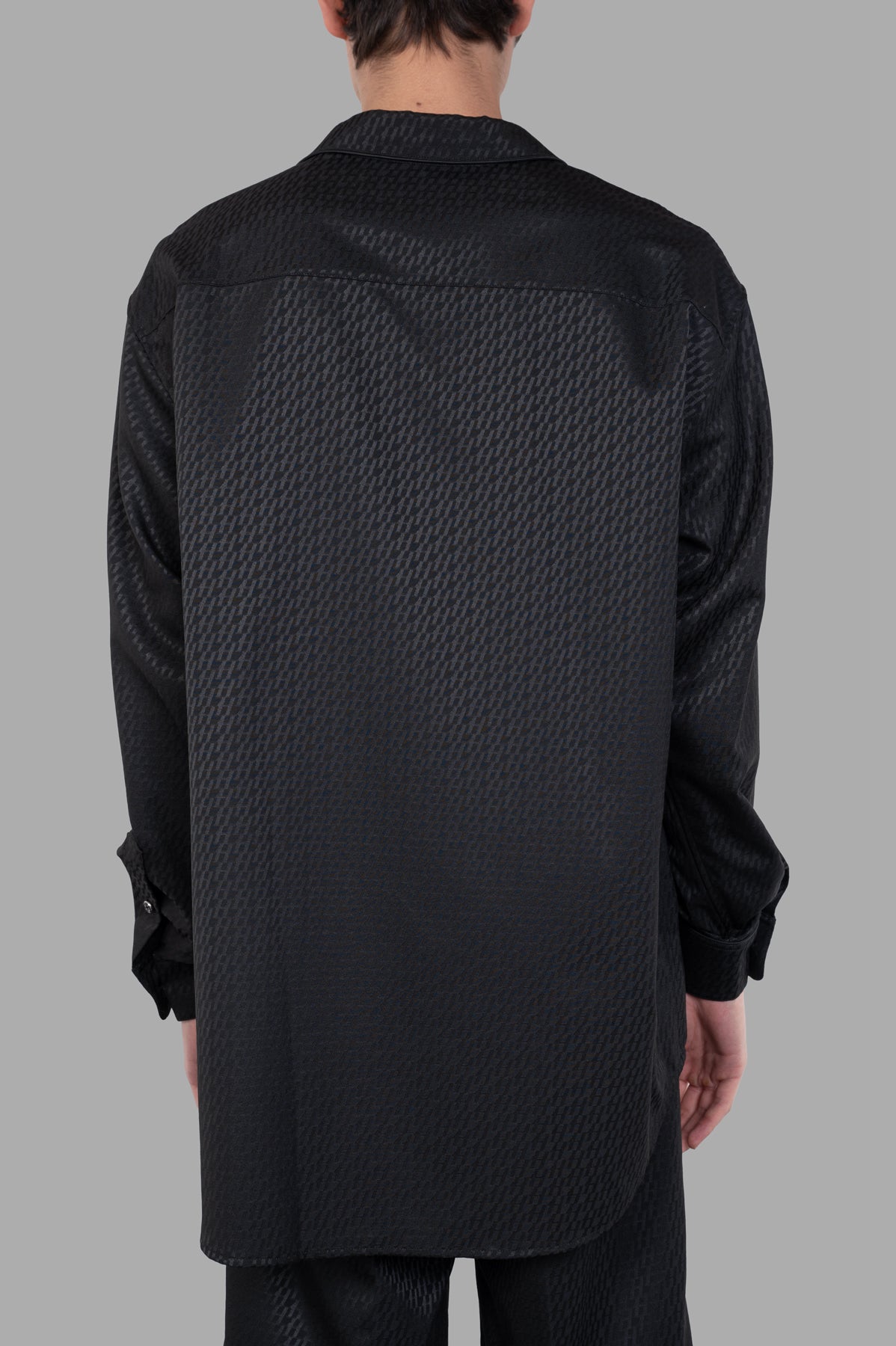 Helmut Lang Oversized PJ Shirt, black satin jacquard with a smooth texture, shown from the back with classic piping details.