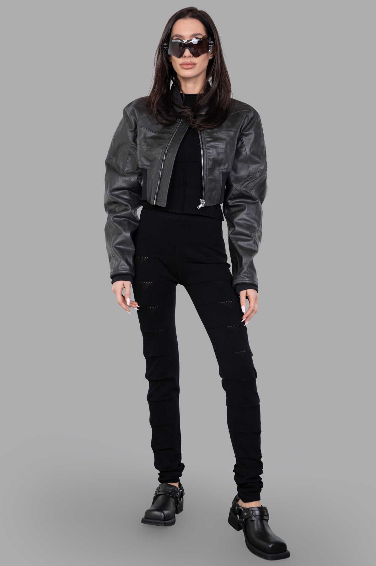 Rick Owens black knit leggings modeled, front view. High-waist, textured design offers a flattering silhouette.