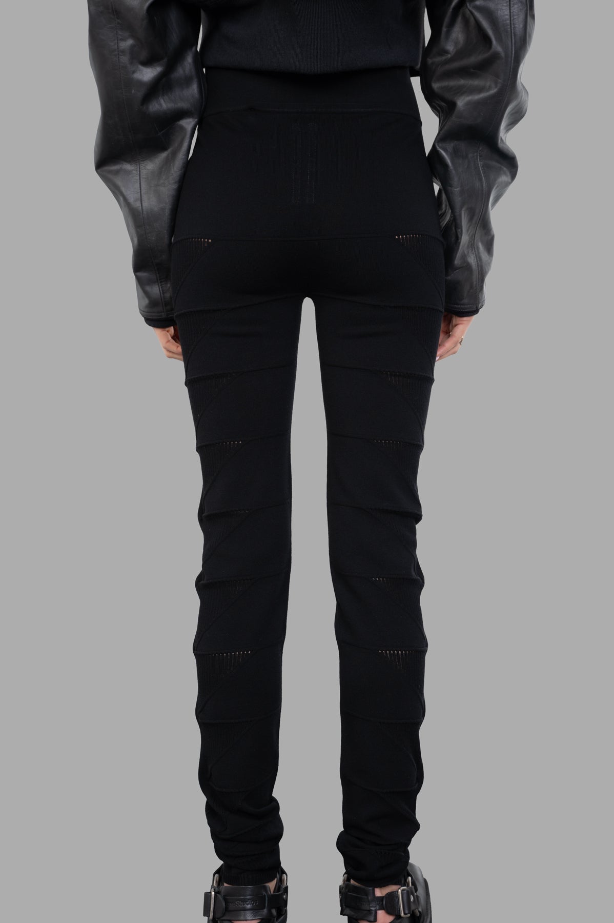 Rick Owens Knit Leggings featuring a high waist, textured fabric, showcased from the back on a model. Color: Black.
