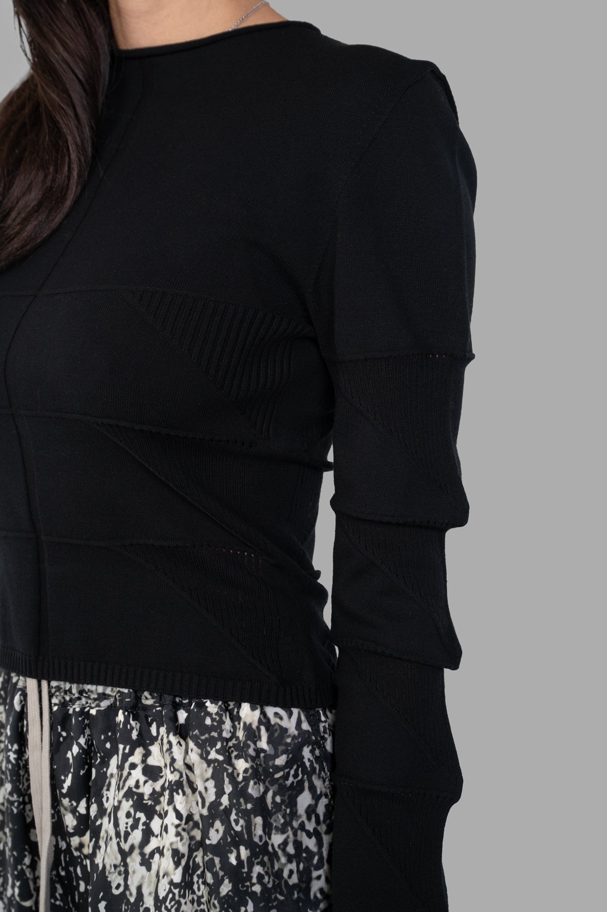 Rick Owens Cropped Knit Blouse showcases intricate detailing and a sleek fit, featuring long sleeves in black knit texture.