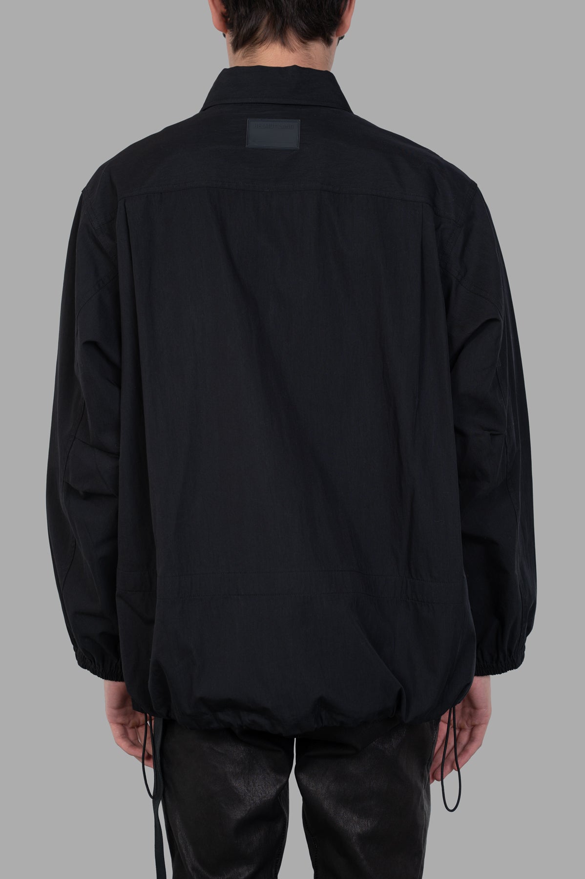 Helmut Lang Uniform Shirt in black, showcasing the back view with cinched hem and soft cotton-nylon blend texture.