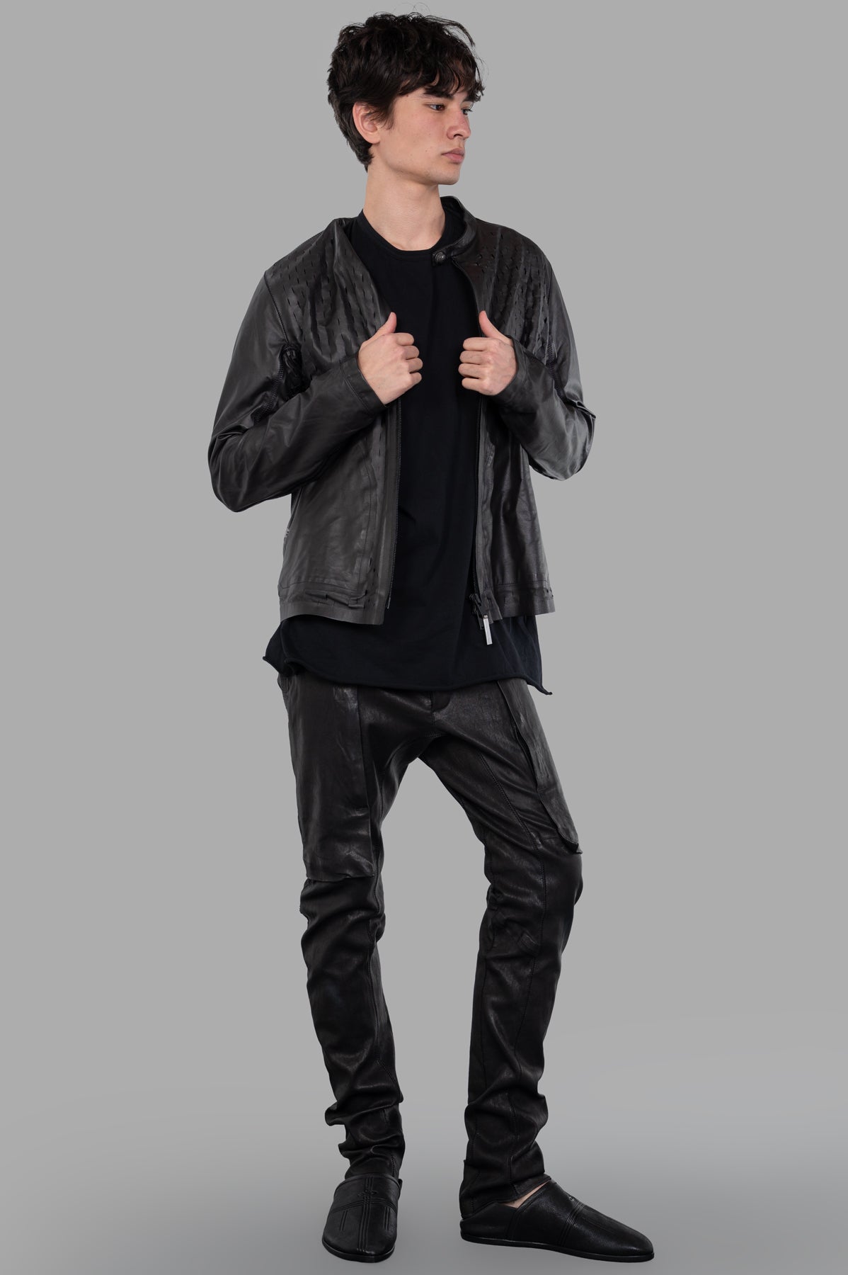 Isaac Sellam Syderal Jacket in black leather, front view on model, featuring laser-cut detailing and round collar.