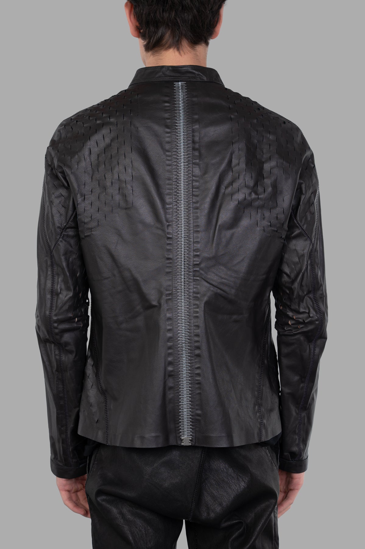 Isaac Sellam. Back view of the Syderal Jacket showcasing unique spine detailing and laser-cut accents in black leather.