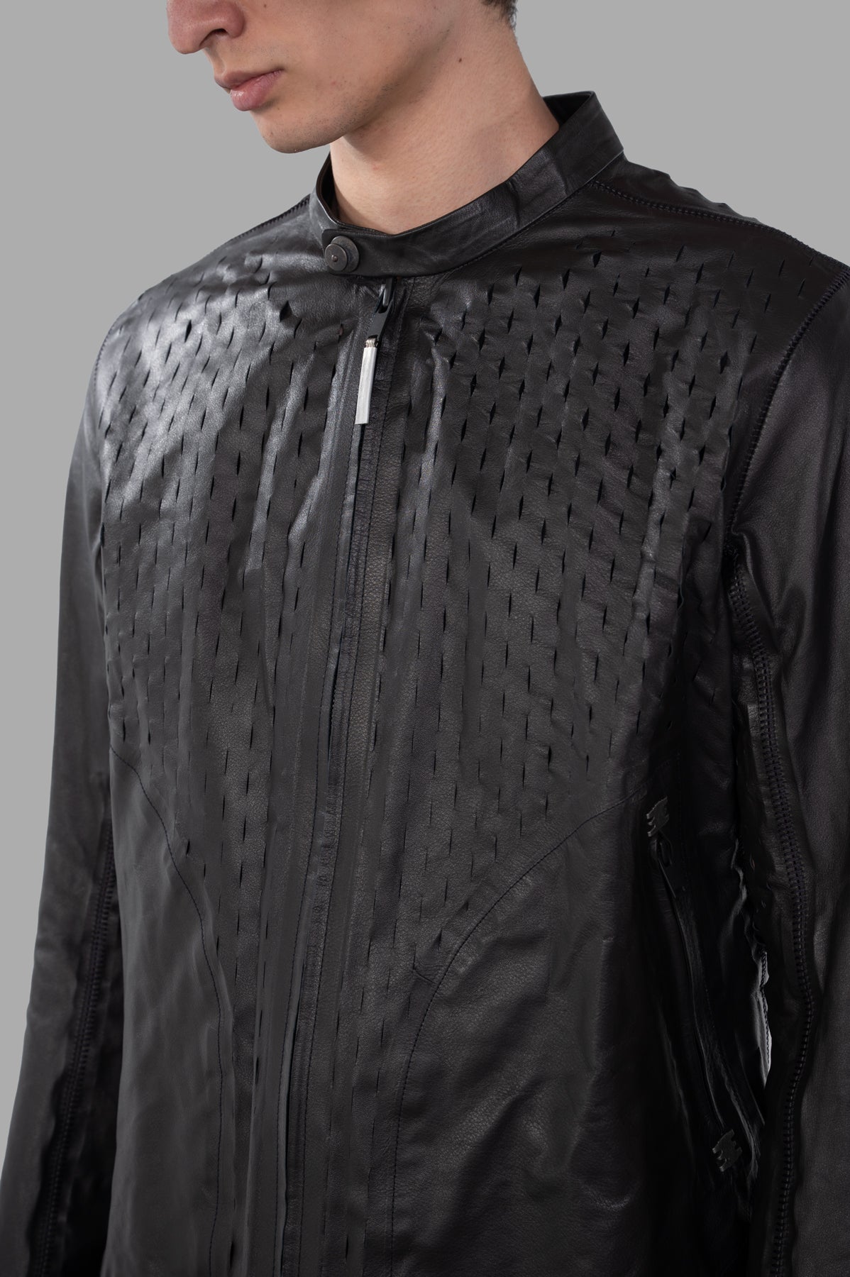Isaac Sellam Syderal Jacket close-up showing laser-cut detailing and bold front zip in luxurious black leather.