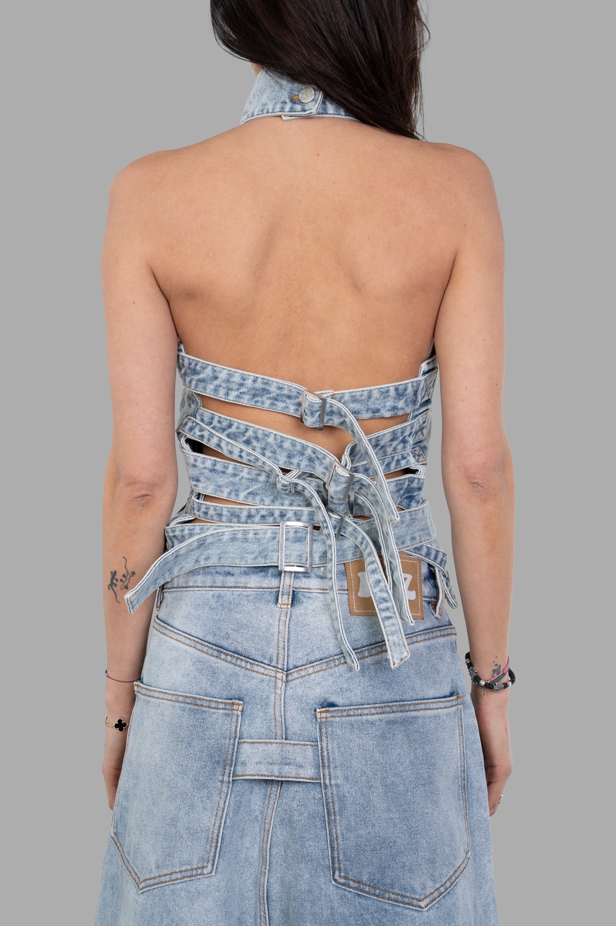Natasha Zinko Treated Strapped-in Top, denim halter style, showcasing a unique back design with tie detailing. Color: Blue.