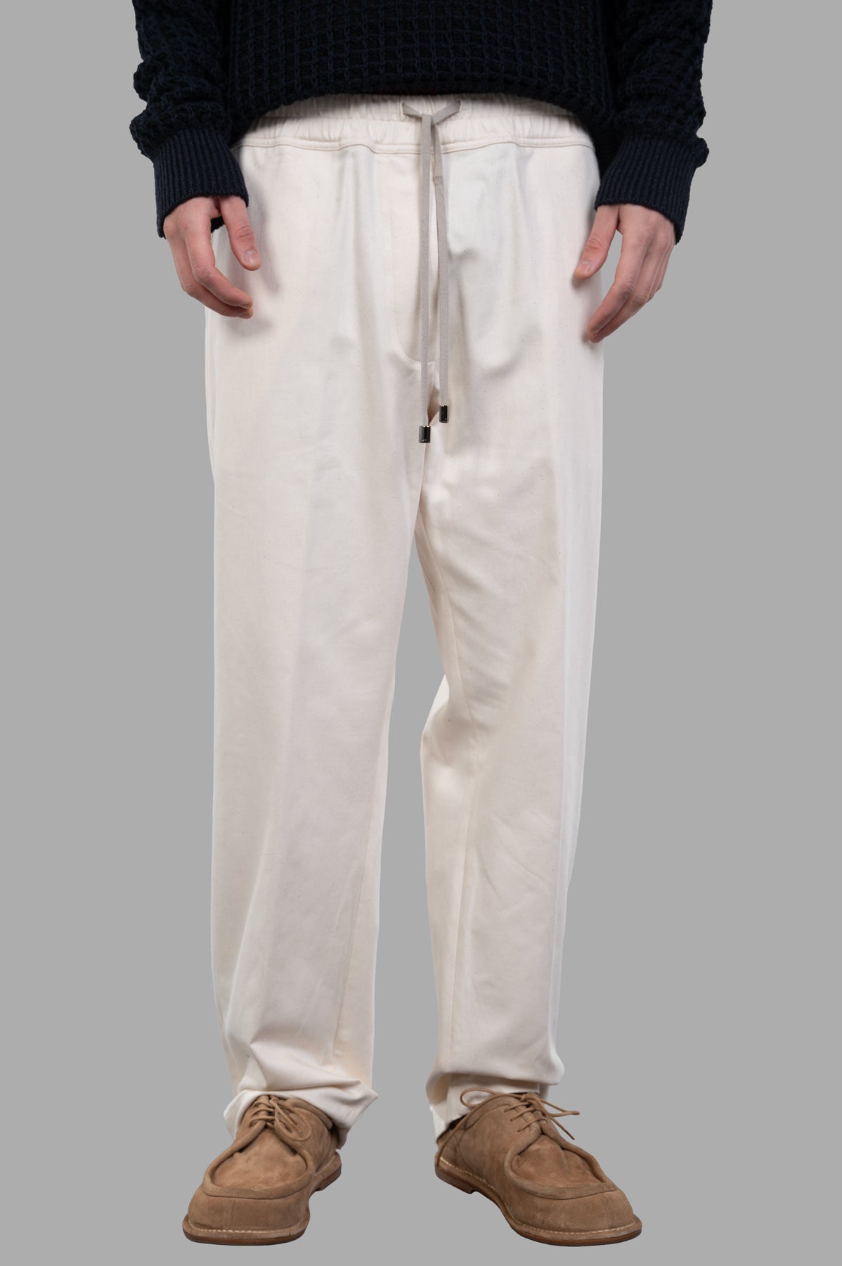 AION Drawstring Pants featuring a relaxed fit, elasticized waist, and drawstring detail in chic ecru color, styled on model.