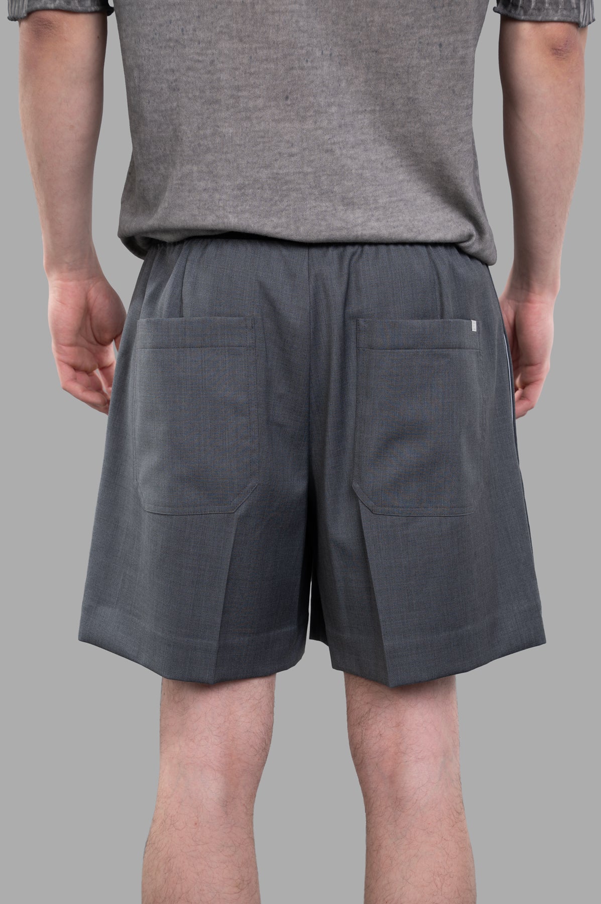 Helmut Lang Pull-On Car Shorts in grey, featuring a tailored straight leg cut and visible back pockets. 100% Virgin Wool.