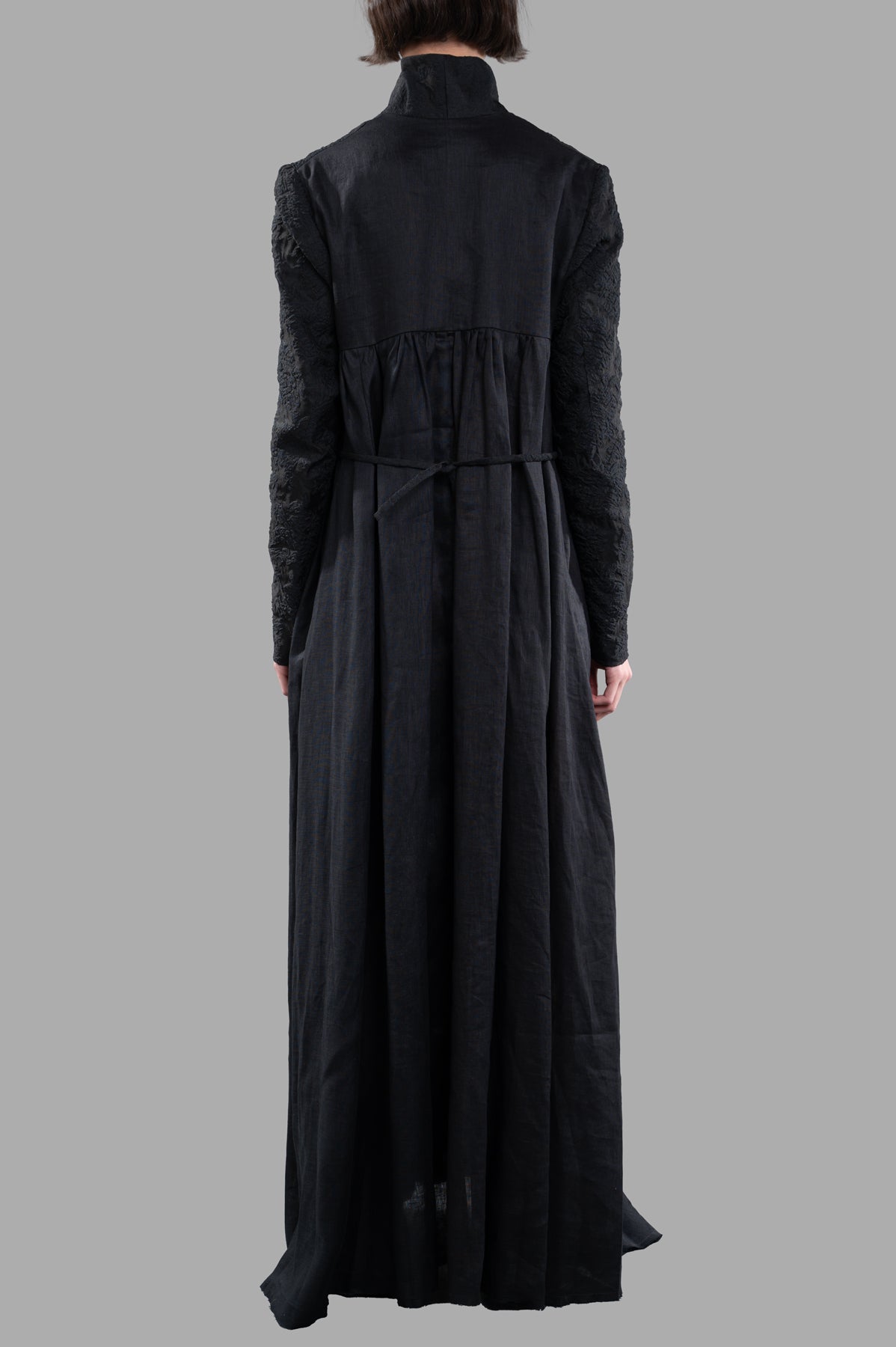 Marc Point Long Dress Coat displayed from the back, featuring a unique design with textured sleeves and a flattering.