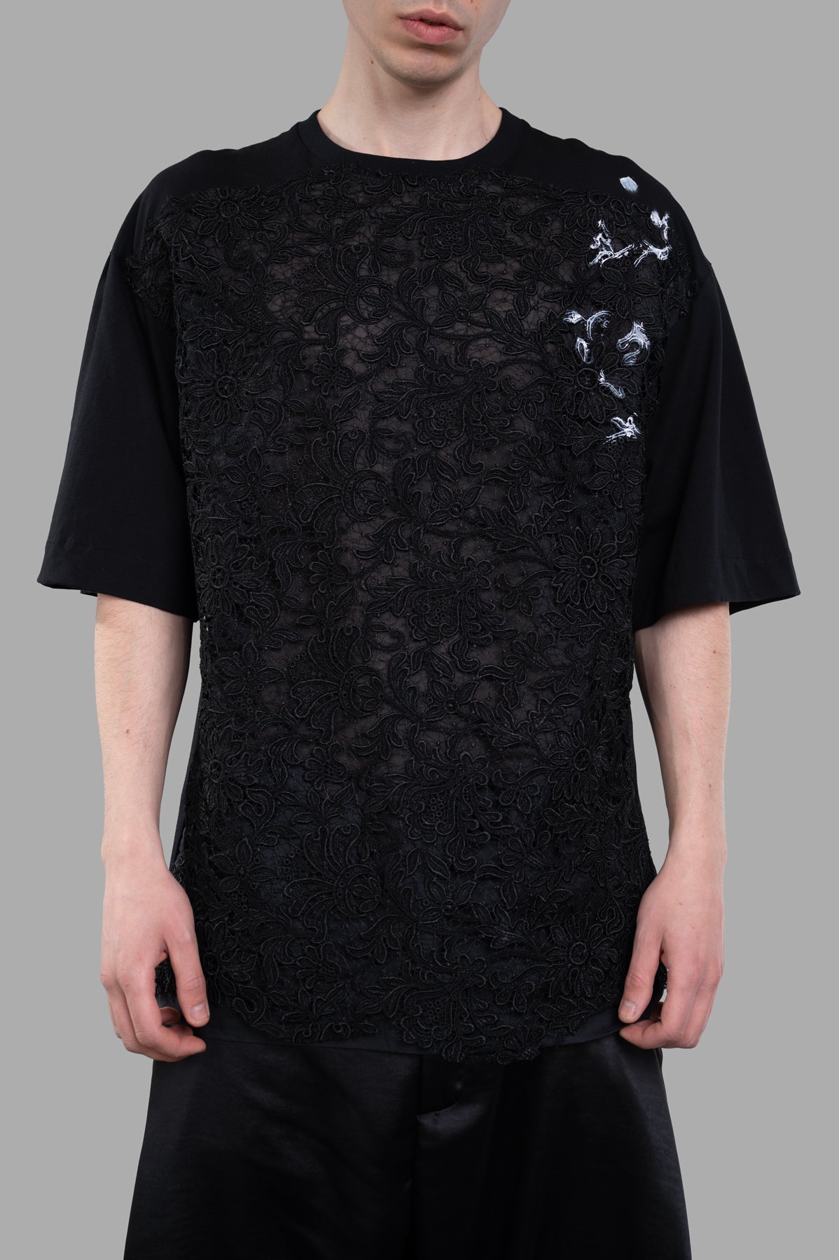 Giovanni Cavagna Lace-detail T-shirt showcasing a unique lace design on the front, paired with an oversized fit in black.