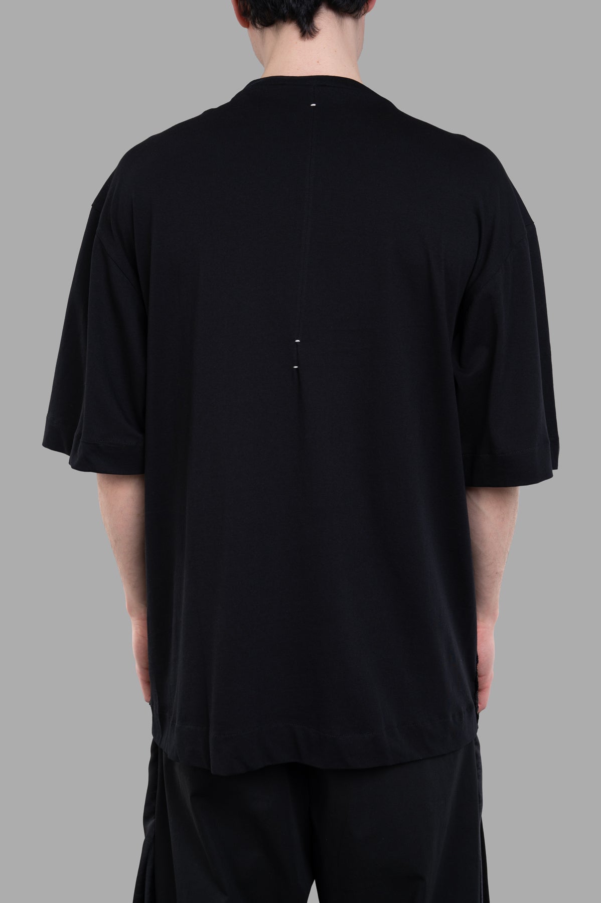 Giovanni Cavagna Lace-detail T-shirt, oversized black tee shown from the back, revealing unique seam detail and relaxed fit.