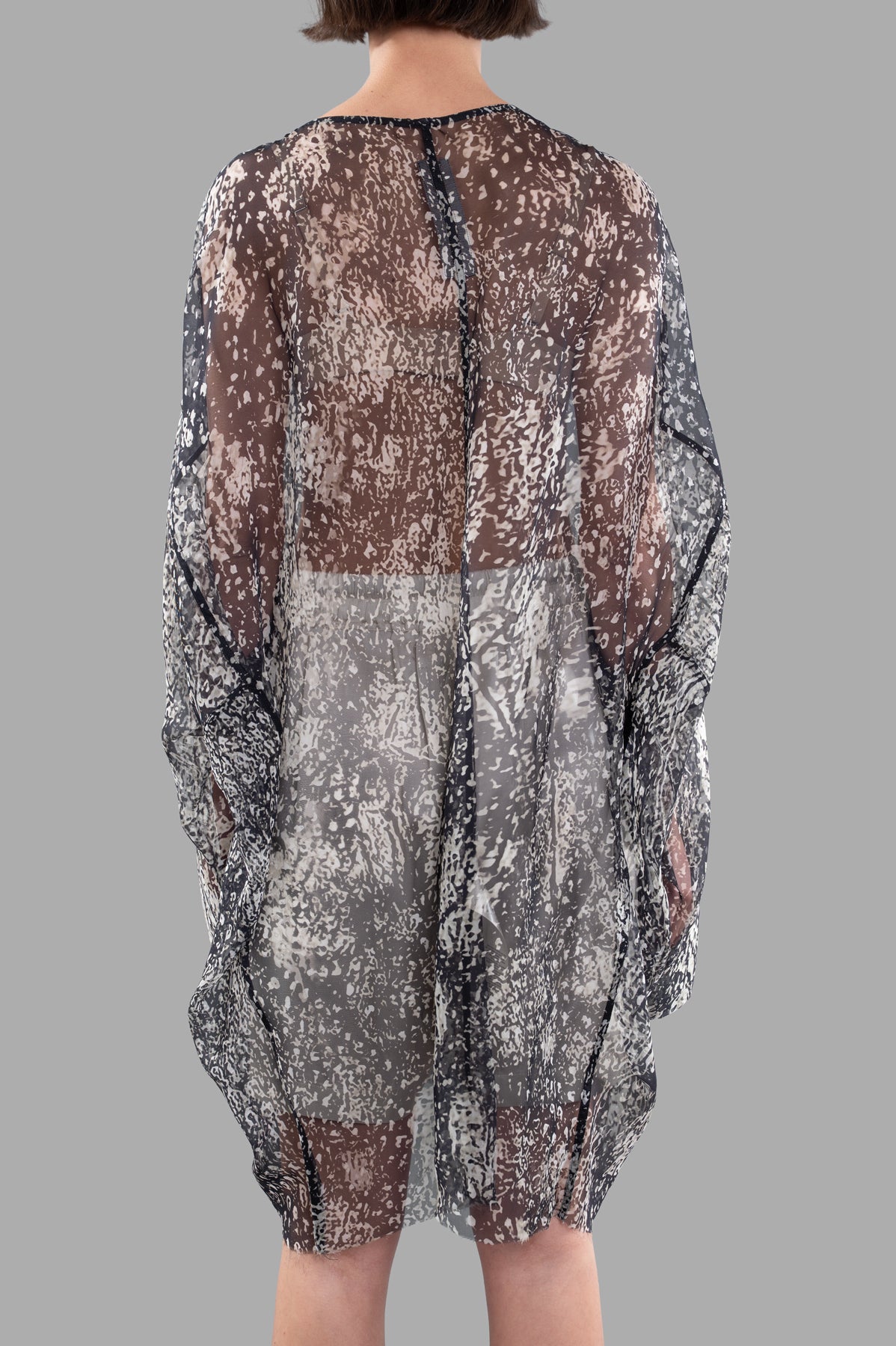 Rick Owens Transparent Tunic shown from the back, features flowing 100% silk fabric in a bold black and white design.