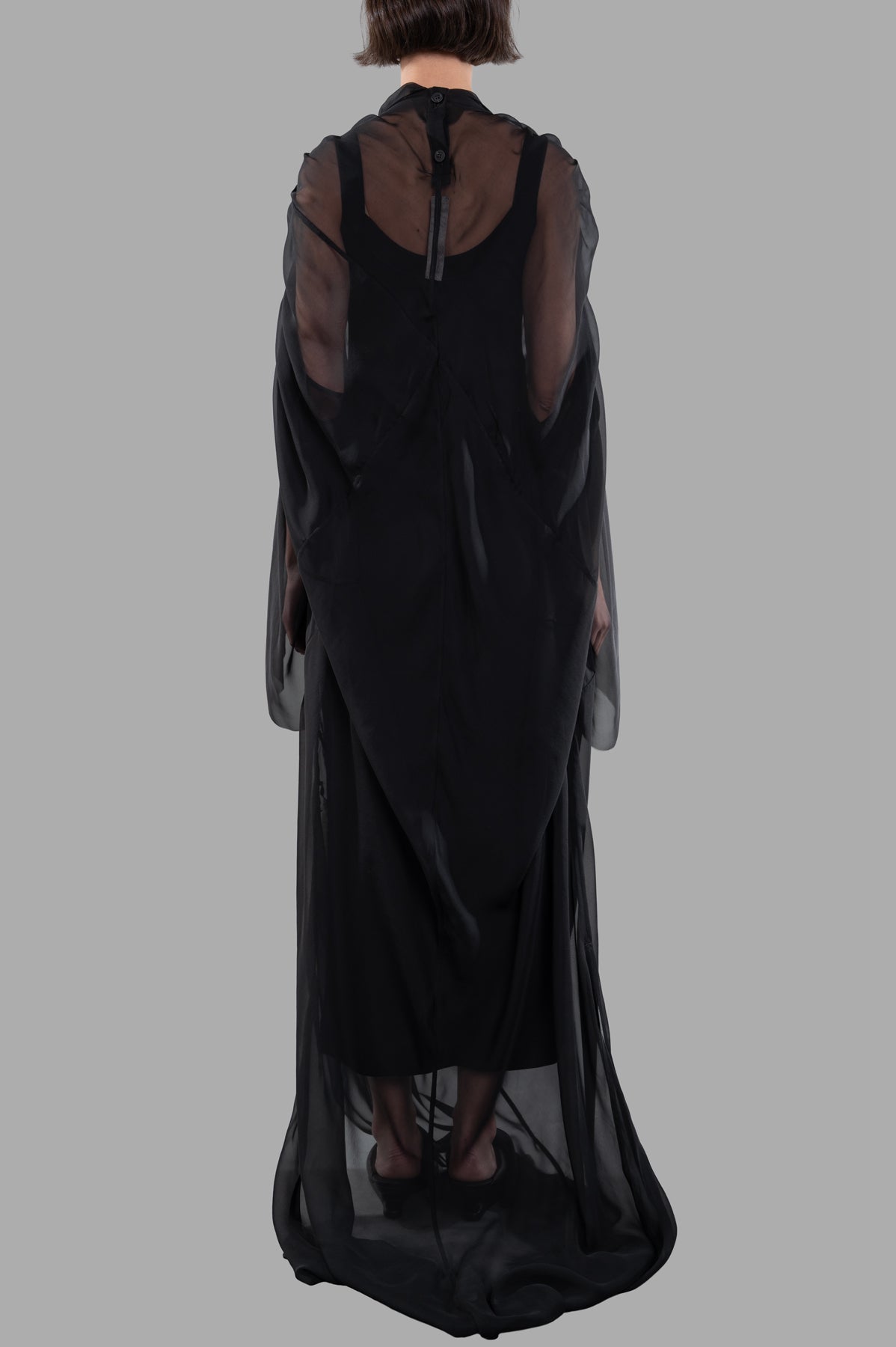 Rick Owens Draped Semi-Sheer Maxi Dress displayed from the back, showcasing elegant draping and delicate ruching in black silk.