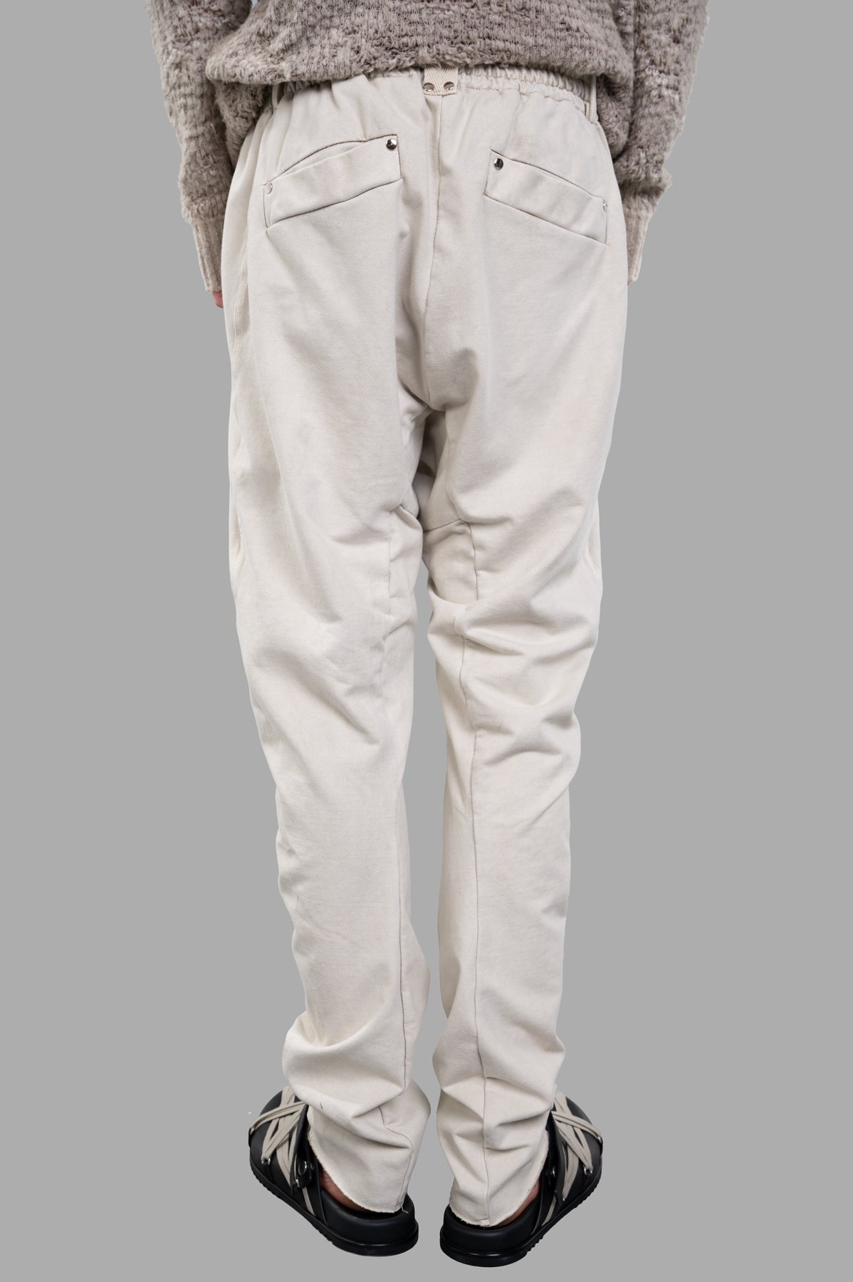 Masnada Drop-crotch Pants in ecru, showcasing the back view with elasticized waist and detailed pockets.