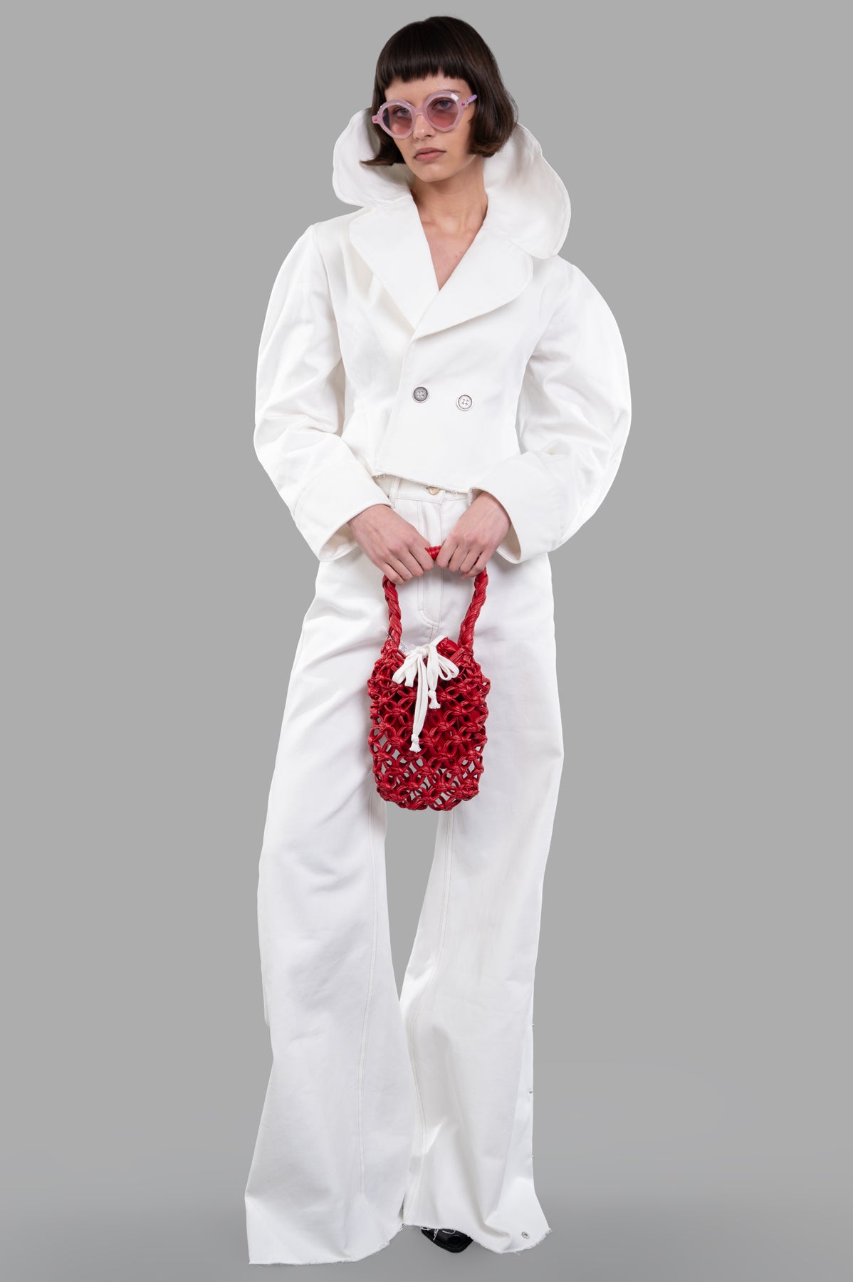 Sehnsucht Atelier Double-breasted Cropped Jacket in white, front view, wide lapels, worn by model, retro vibe.
