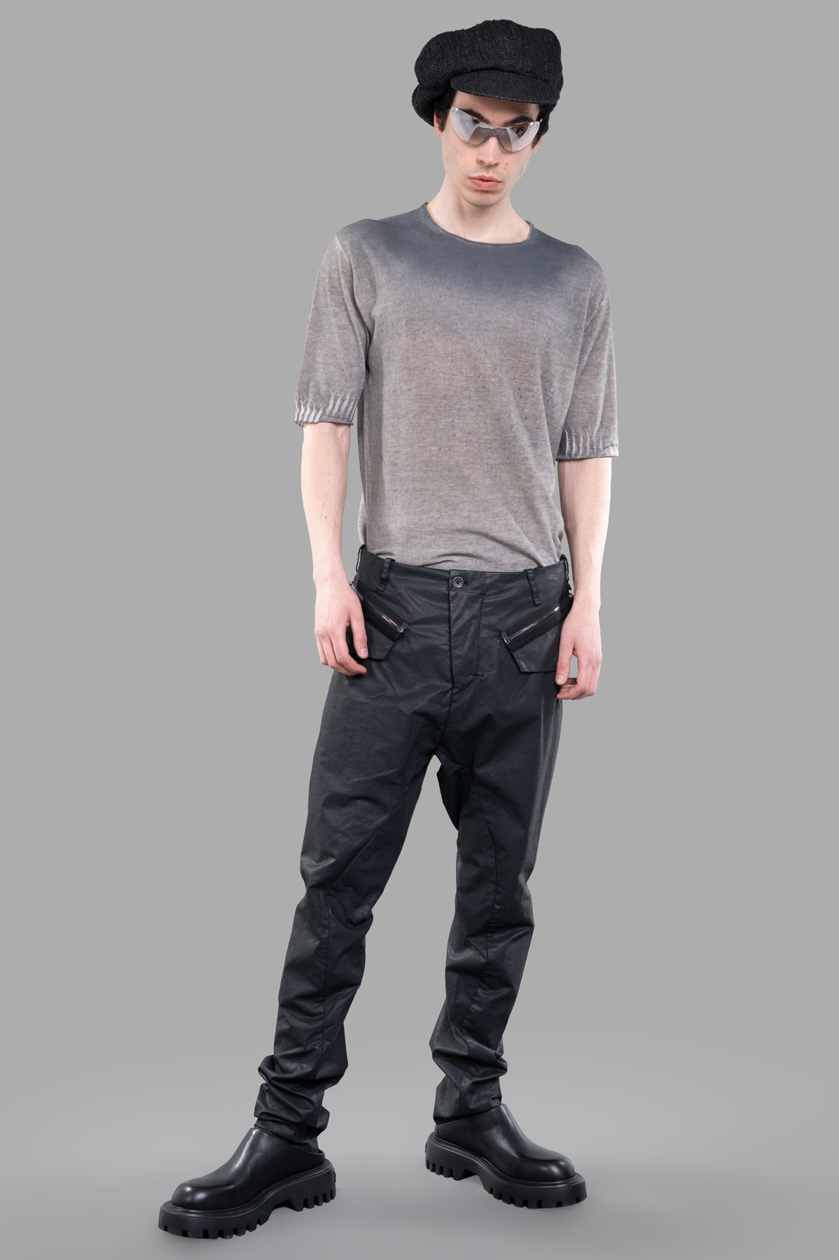 Masnada Coated Drop-crotch Pants in black, on-model front view, showcasing cargo pockets and sleek design.