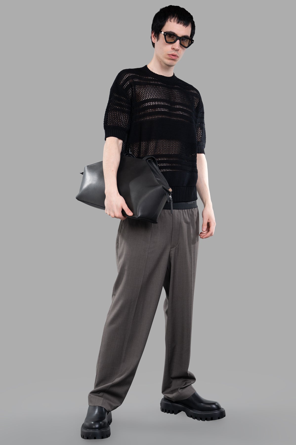 AION Perforated-mesh T-shirt in black, modeled front view, showcasing ribbed knit texture and short sleeves.