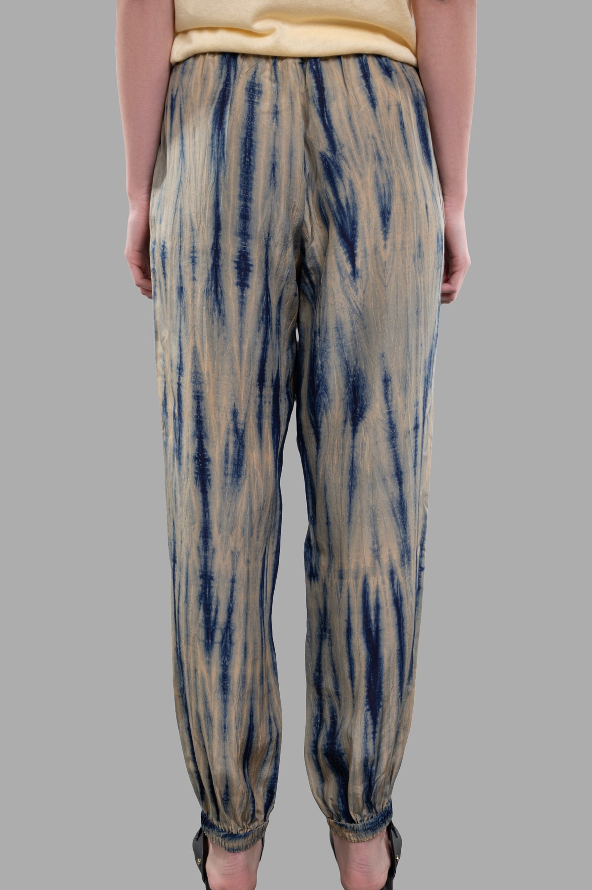 Joseph Tie-dye Silk Trousers shown from the back, featuring a relaxed fit and unique sand/navy pattern in luxurious habotai.