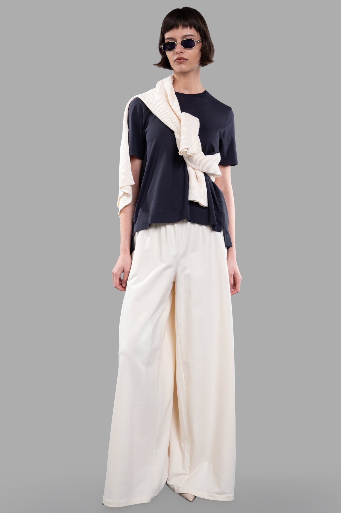 Norma Kamali Wide-leg Trousers in Ecru shown on model with elastic waist, highlighting chic style and comfort.